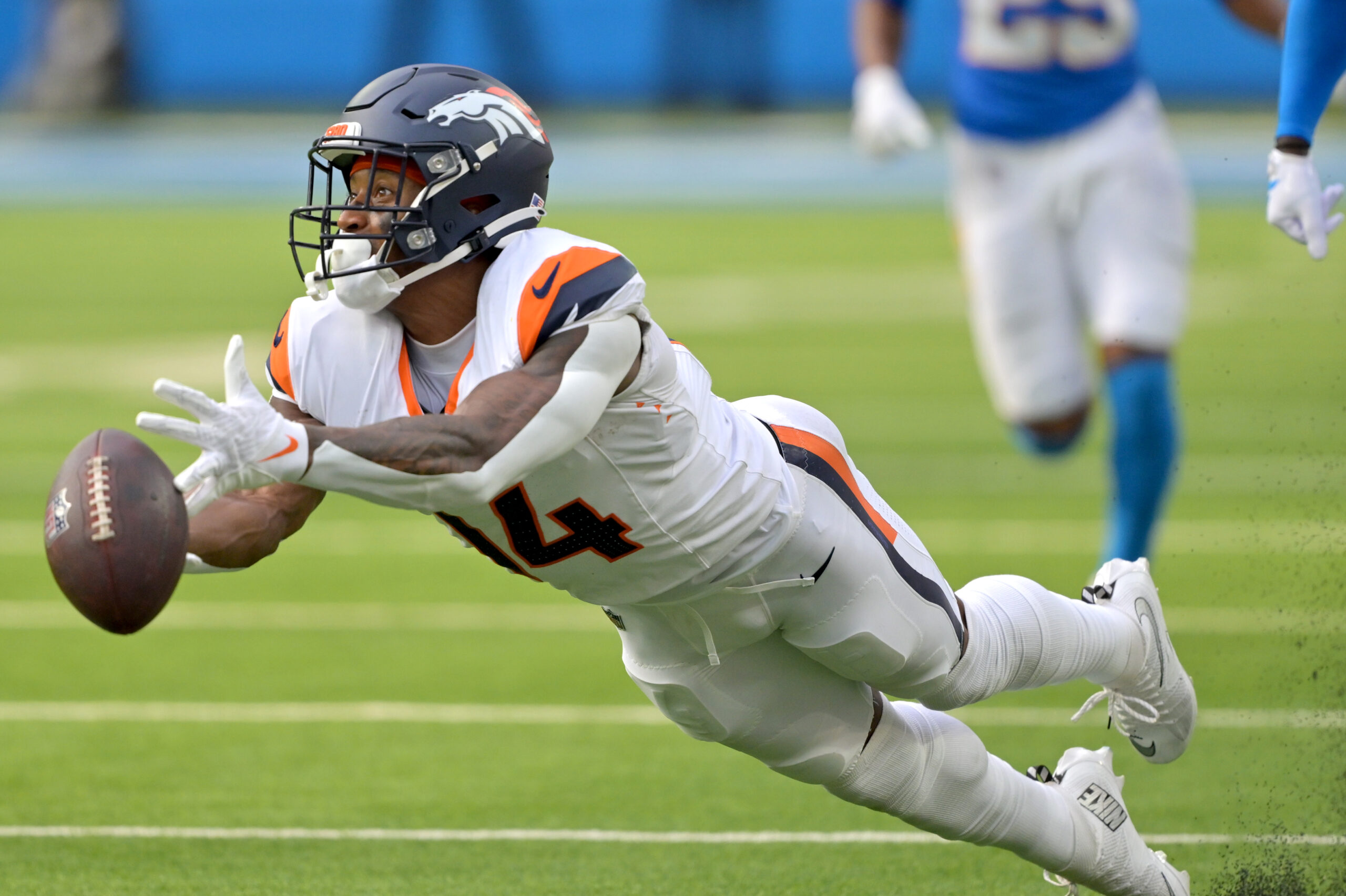 Sep 21, 2025; Inglewood, California, USA; Denver Broncos wide receiver Courtland Sutton (14) reaches for a long pass 4th down in the second half against the Los Angeles Chargers at SoFi Stadium. Mandatory Credit: Jayne Kamin-Oncea-Imagn Images
