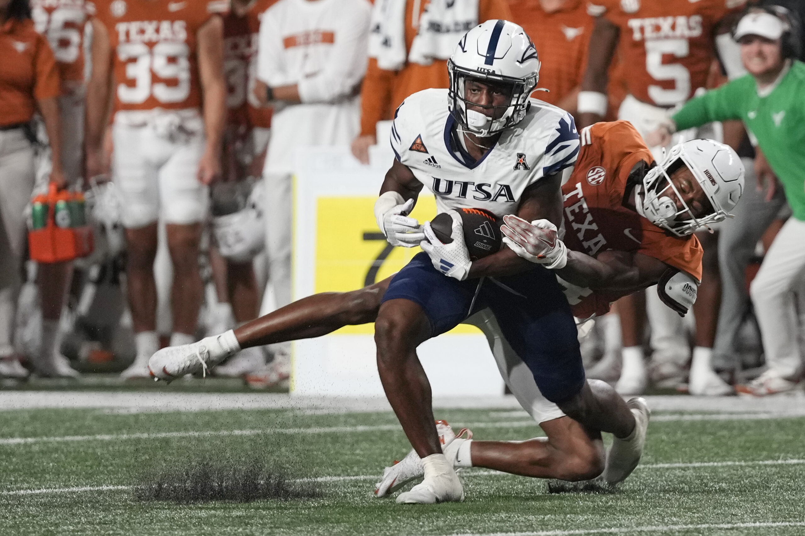 Sep 14, 2024; Austin, Texas, USA; Texas Longhorns defensive back Warren Roberson (24) tackles Texas Roadrunners wide receiver Devin McCuin (3) during the second half at Darrell K Royal-Texas Memorial Stadium. Mandatory Credit: Scott Wachter-Imagn Images
