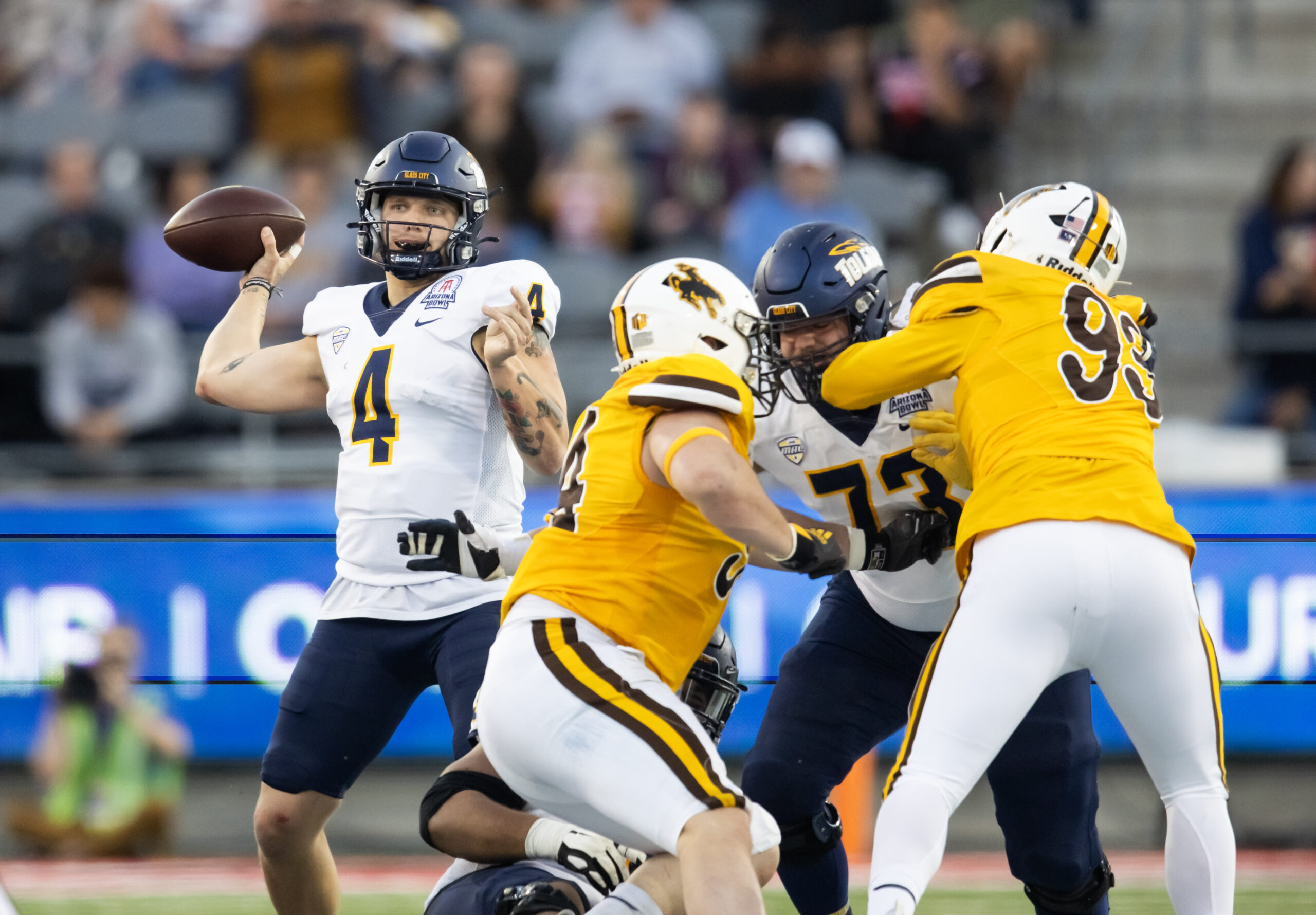Dec 30, 2023; Tucson, AZ, USA; Toledo Rockets quarterback Tucker Gleason (4) against the Wyoming Cowboys in the Arizona Bowl at Arizona Stadium. Mandatory Credit: Mark J. Rebilas-USA TODAY Sports