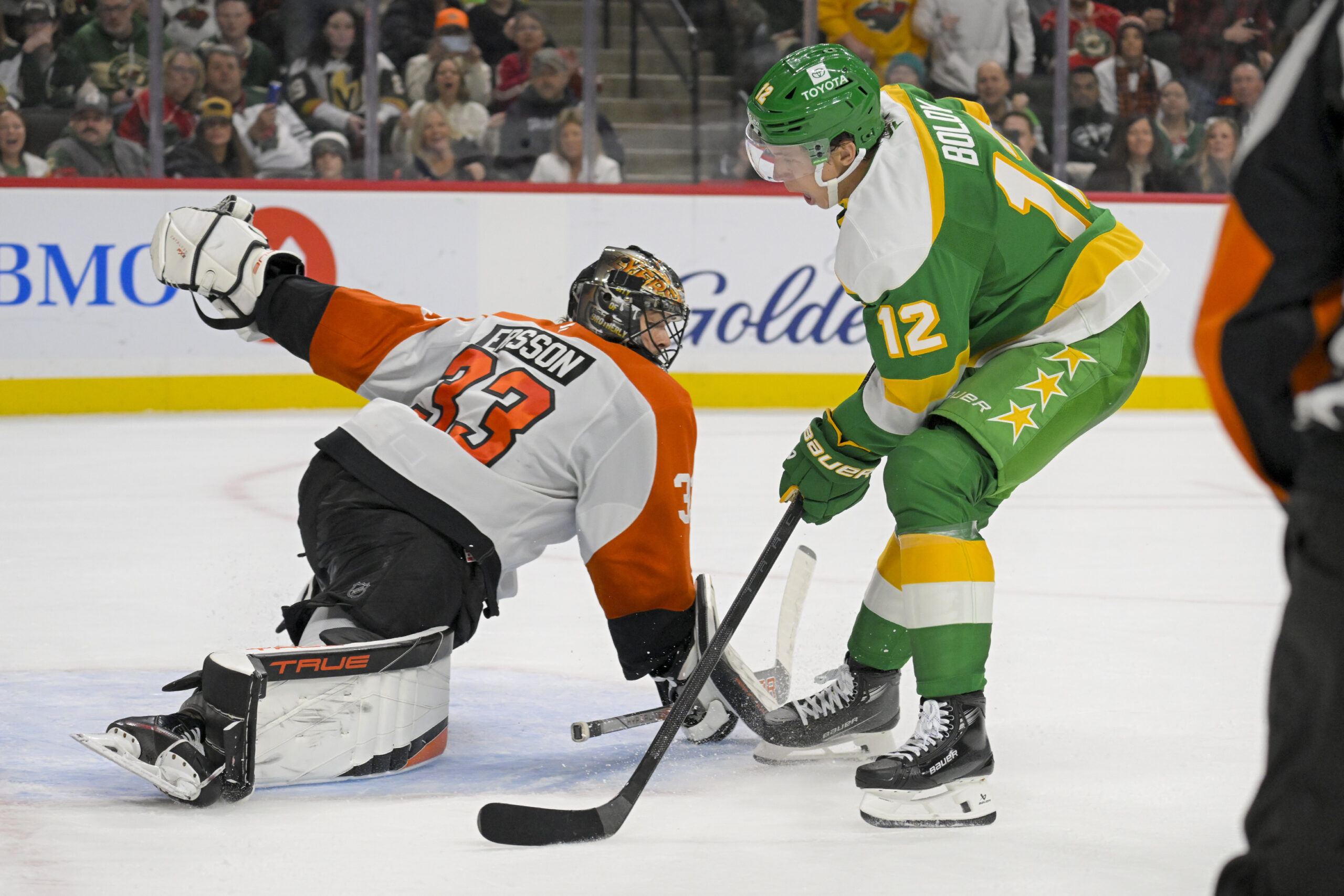 Dec 14, 2024; Saint Paul, Minnesota, USA; Minnesota Wild forward Matt Boldy (12) scores a breakaway goal against Philadelphia Flyers goalie Samuel Ersson (33) during the second period at Xcel Energy Center. Mandatory Credit: Nick Wosika-Imagn Images