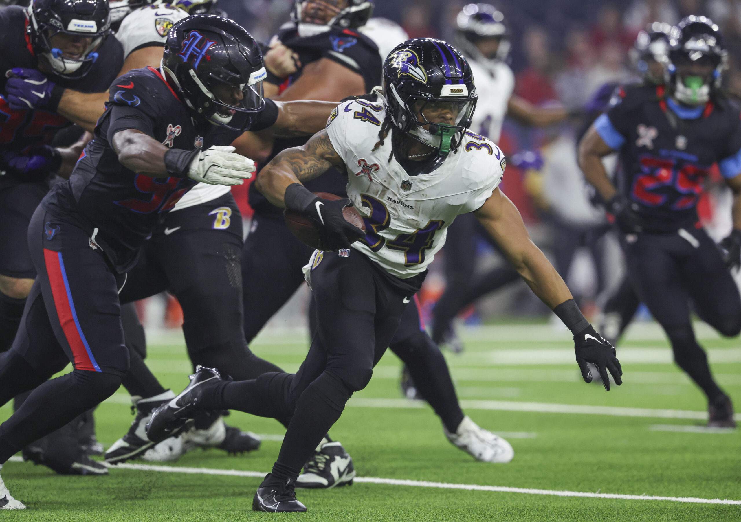 Dec 25, 2024; Houston, Texas, USA;  Baltimore Ravens running back Keaton Mitchell (34) runs with the ball during the fourth quarter against the Houston Texans at NRG Stadium. Mandatory Credit: Troy Taormina-Imagn Images