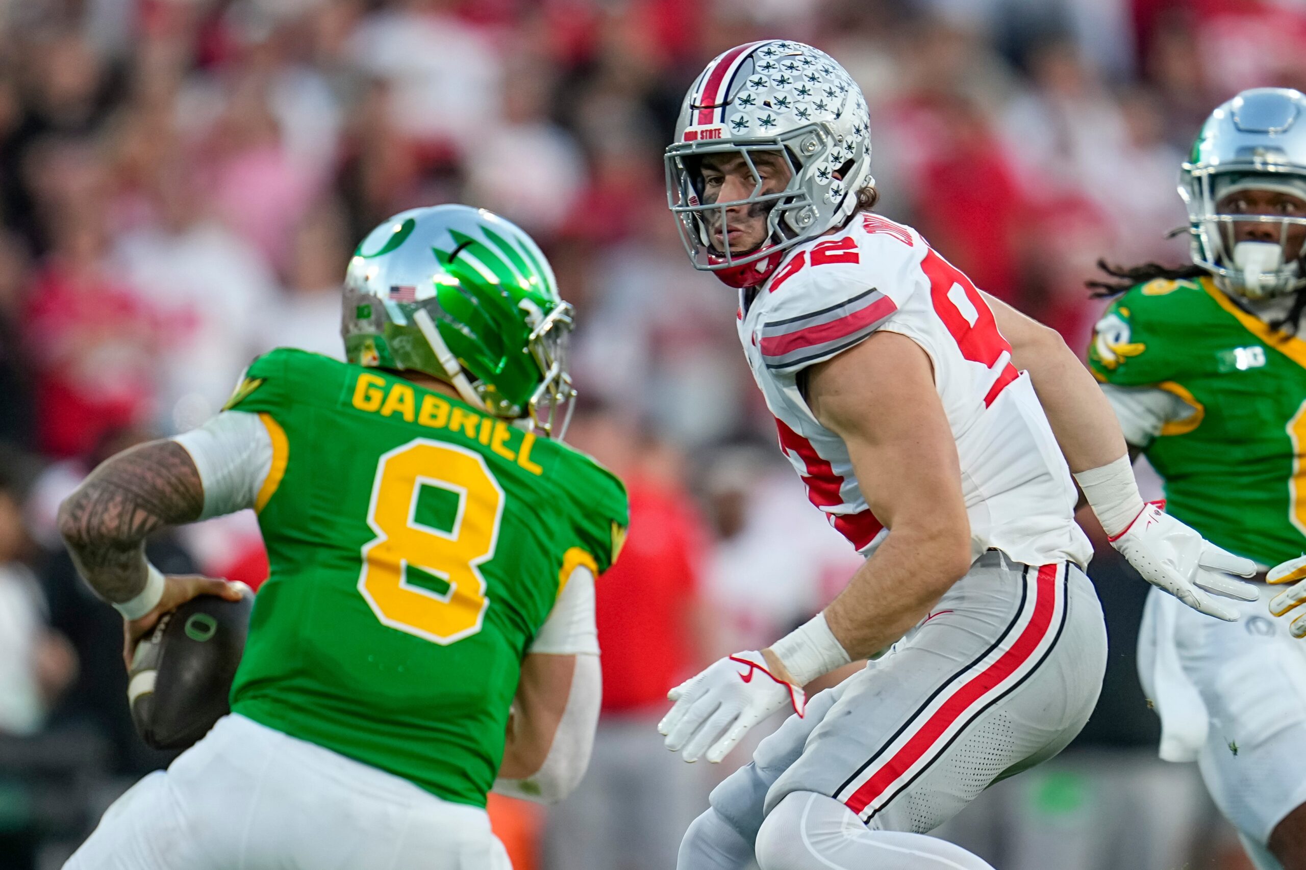 Ohio State Buckeyes defensive end Caden Curry (92) pursues Oregon Ducks quarterback Dillon Gabriel (8) during the College Football Playoff quarterfinal at the Rose Bowl in Pasadena, Calif. on Jan. 1, 2025. Ohio State won 41-21.