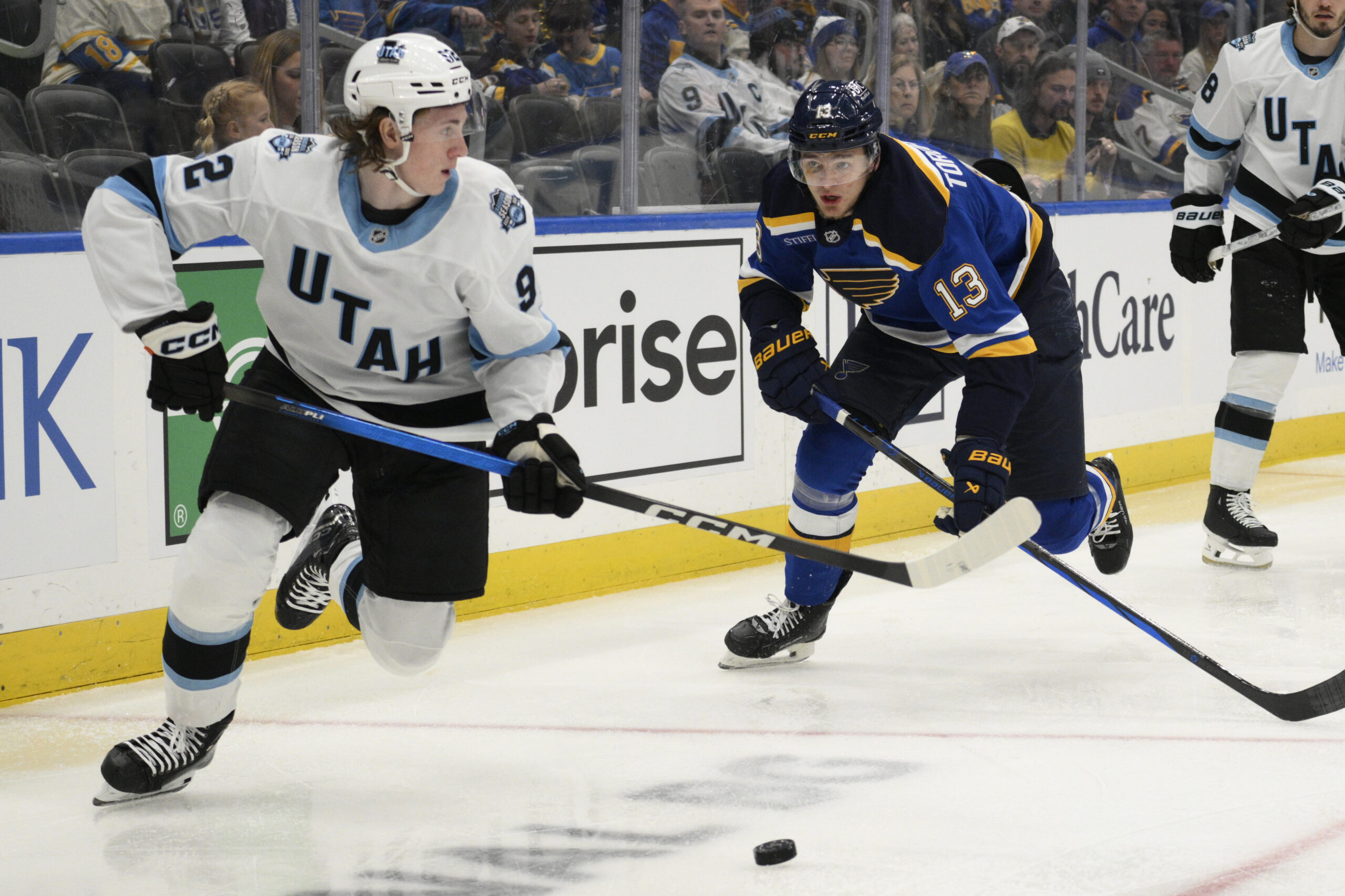 Apr 15, 2025; St. Louis, Missouri, USA; St. Louis Blues right wing Alexey Toropchenko (13) pressures Utah Hockey Club center Logan Cooley (92) during the second period at Enterprise Center. Mandatory Credit: Jeff Le-Imagn Images