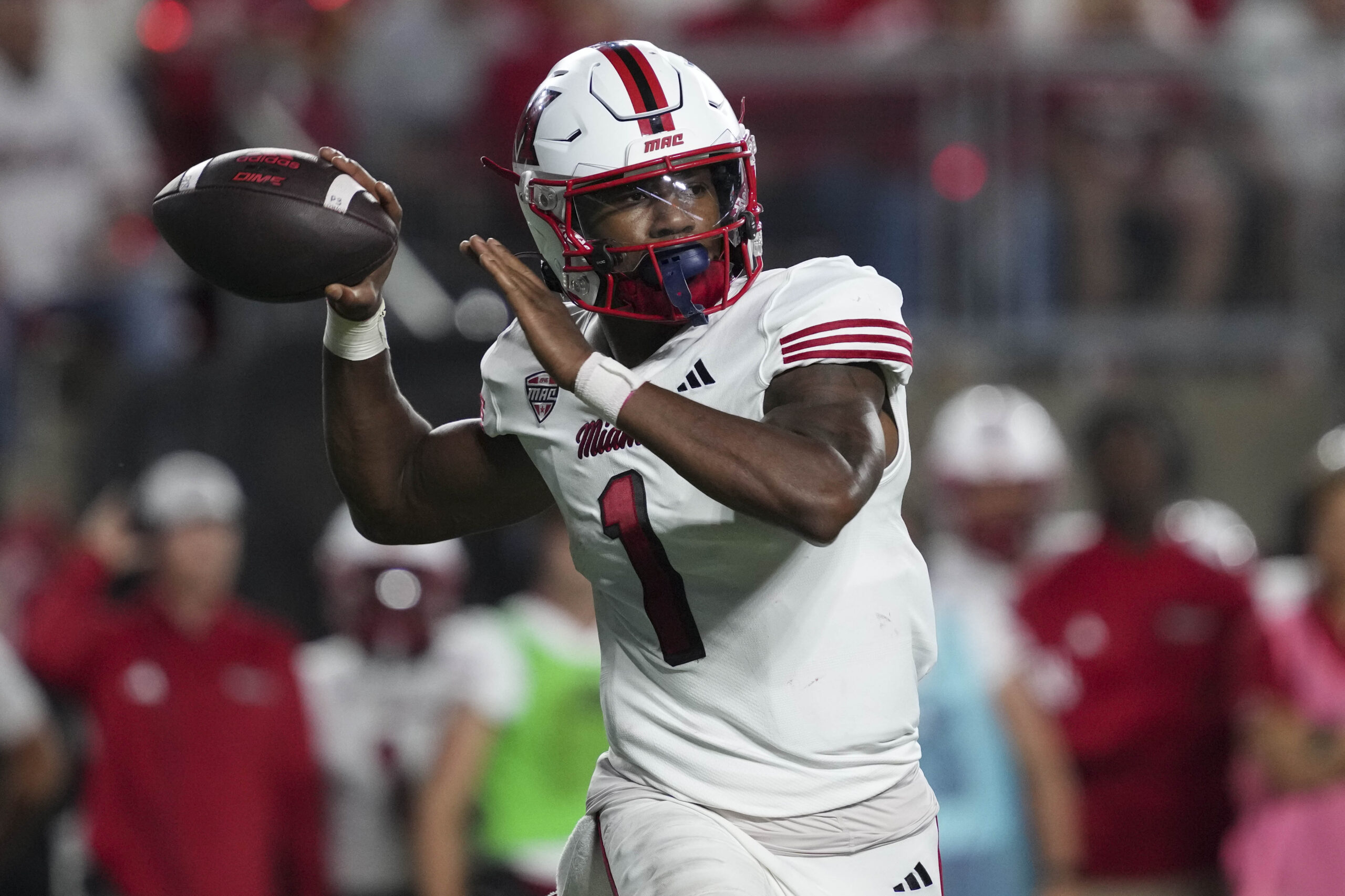 Aug 28, 2025; Madison, Wisconsin, USA;  Miami (OH) RedHawks quarterback Dequan Finn (1) throws a pass during the third quarter against the Wisconsin Badgers at Camp Randall Stadium. Mandatory Credit: Jeff Hanisch-Imagn Images