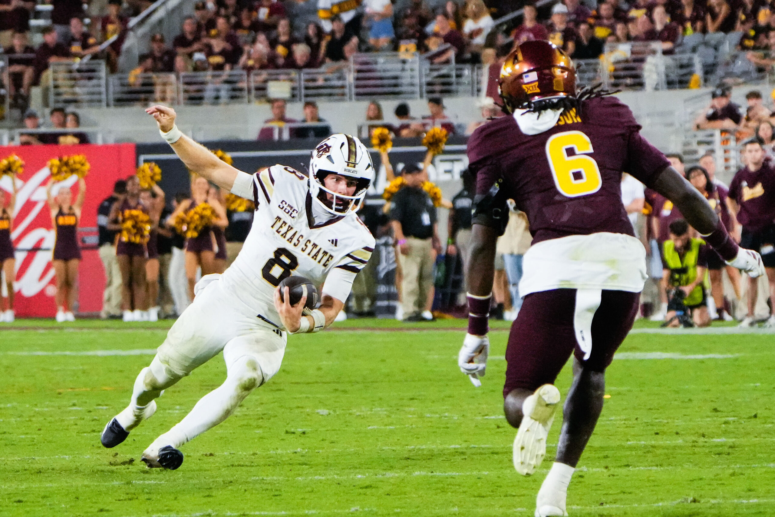 Sep 13, 2025; Tempe, Arizona, USA; Texas State Bobcats quarterback Brad Jackson (8) attempts to avoid a tackle by Arizona State Sun Devils safety Adrian Wilson (6) at Mountain America Stadium. Mandatory Credit: Arianna Grainey-Imagn Images