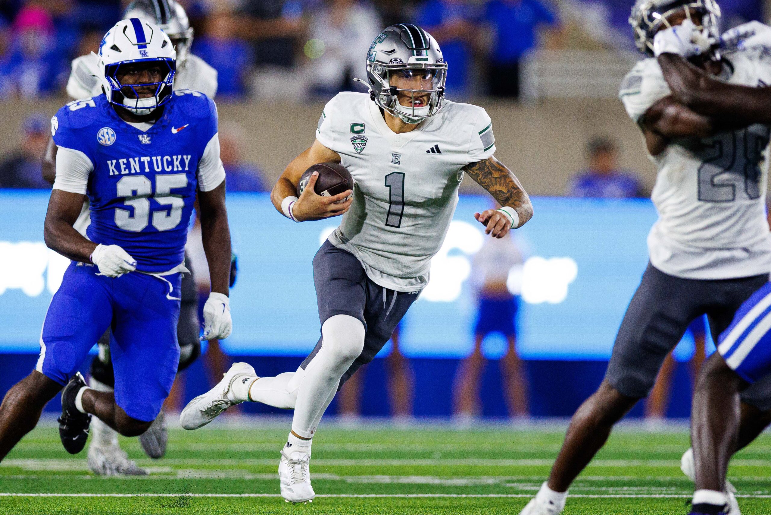 Sep 13, 2025; Lexington, Kentucky, USA; Eastern Michigan Eagles quarterback Noah Kim (1) runs the ball during the third quarter against the Kentucky Wildcats at Kroger Field. Mandatory Credit: Jordan Prather-Imagn Images