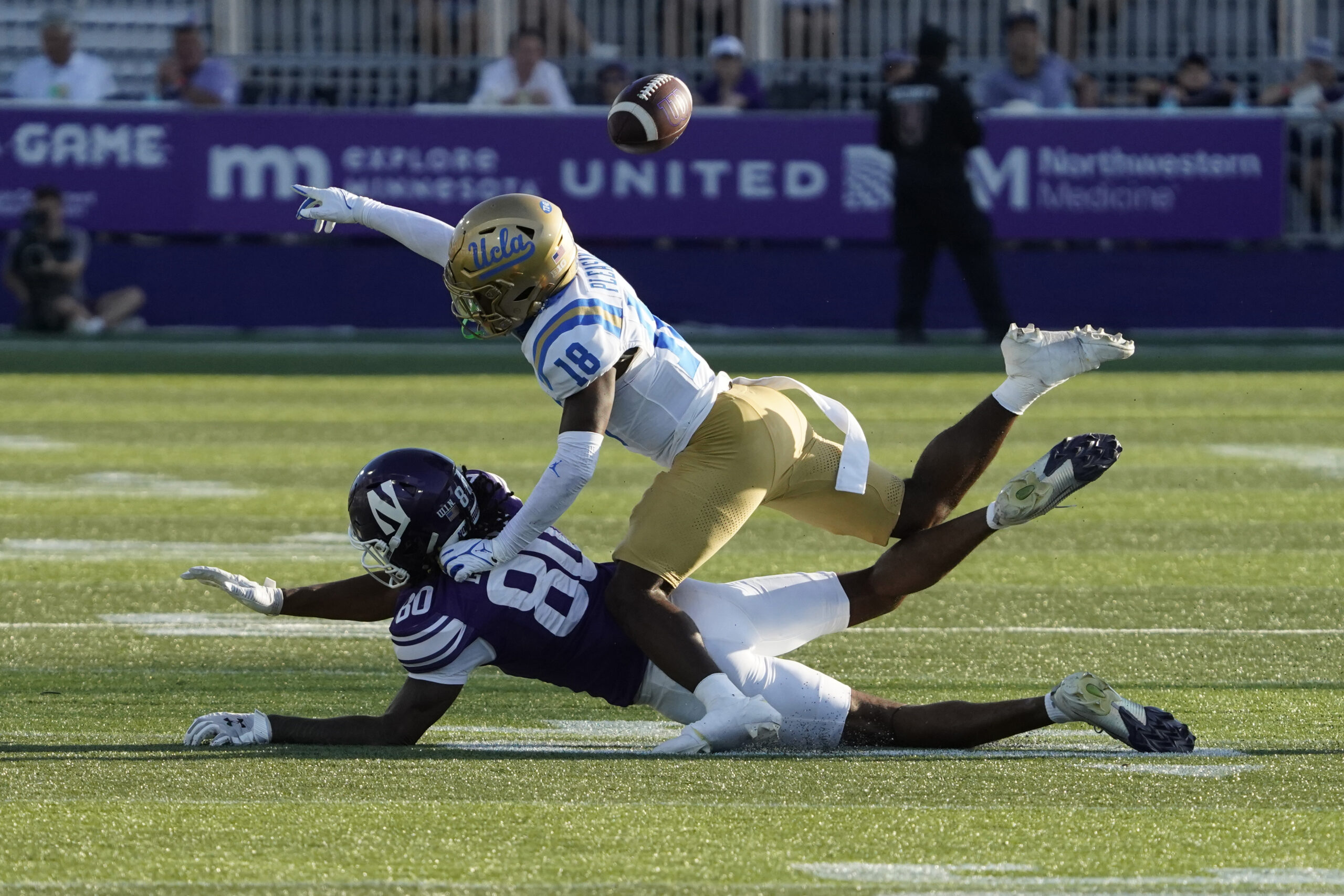 Sep 27, 2025; Evanston, Illinois, USA; UCLA Bruins defensive back Rodrick Pleasant (18) defends Northwestern Wildcats wide receiver Hayden Eligon II (80) during the second half at Northwestern Medicine Field at Martin Stadium. Mandatory Credit: David Banks-Imagn Images