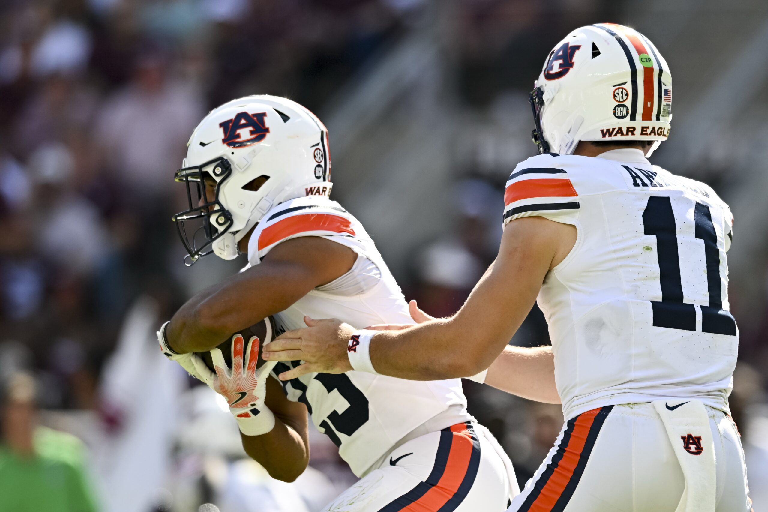 Sep 27, 2025; College Station, Texas, USA; Auburn Tigers quarterback Jackson Arnold (11) hands off the ball to running back Jeremiah Cobb (23) during the first half against the Texas A&M Aggies at Kyle Field. Mandatory Credit: Maria Lysaker-Imagn Images