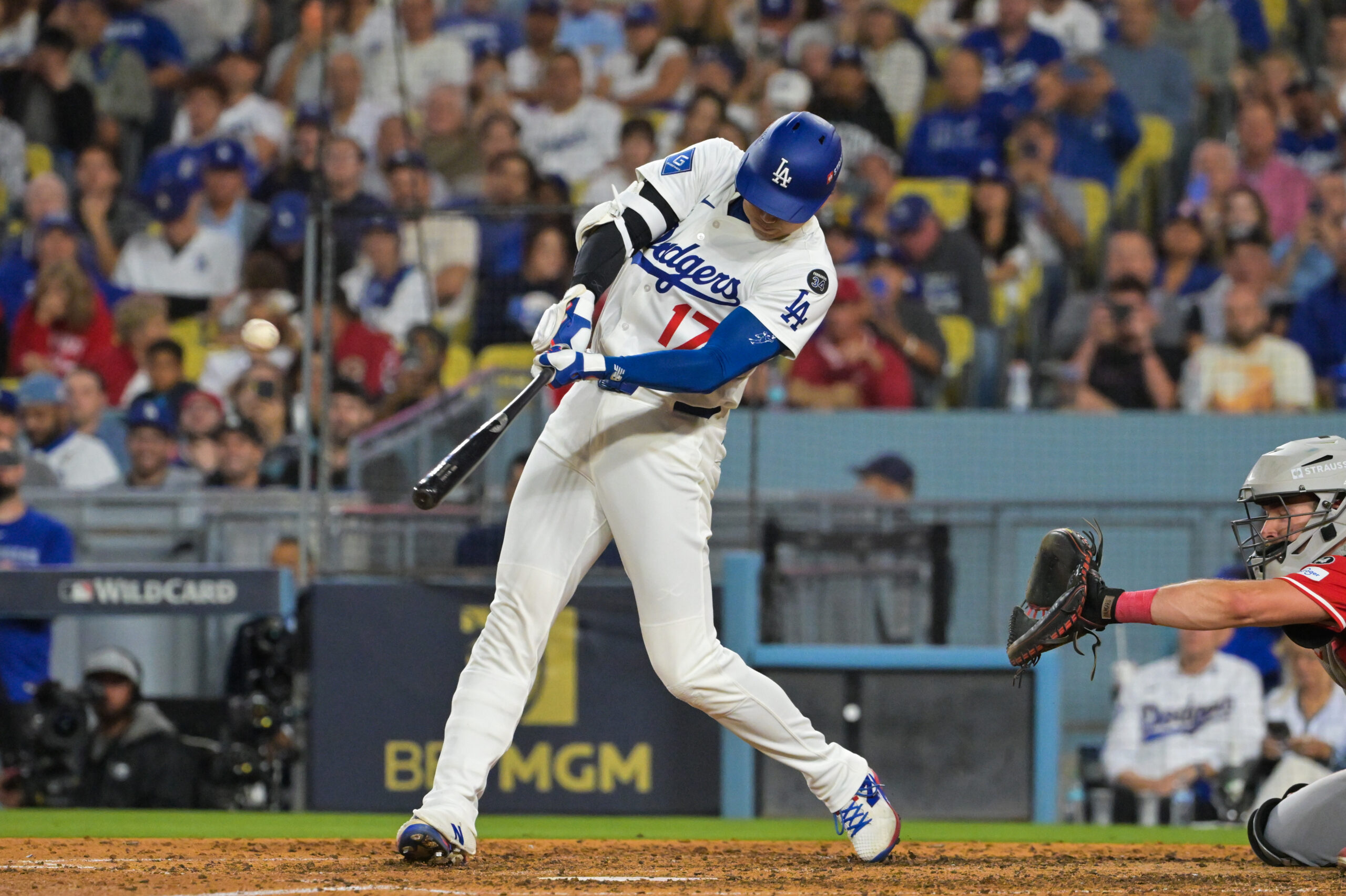 Sep 30, 2025; Los Angeles, California, USA; Los Angeles Dodgers designated hitter Shohei Ohtani (17) hits a two run home run during the sixth inning against the Cincinnati Reds during game one of the Wildcard round for the 2025 MLB playoffs at Dodger Stadium. Mandatory Credit: Jayne Kamin-Oncea-Imagn Images