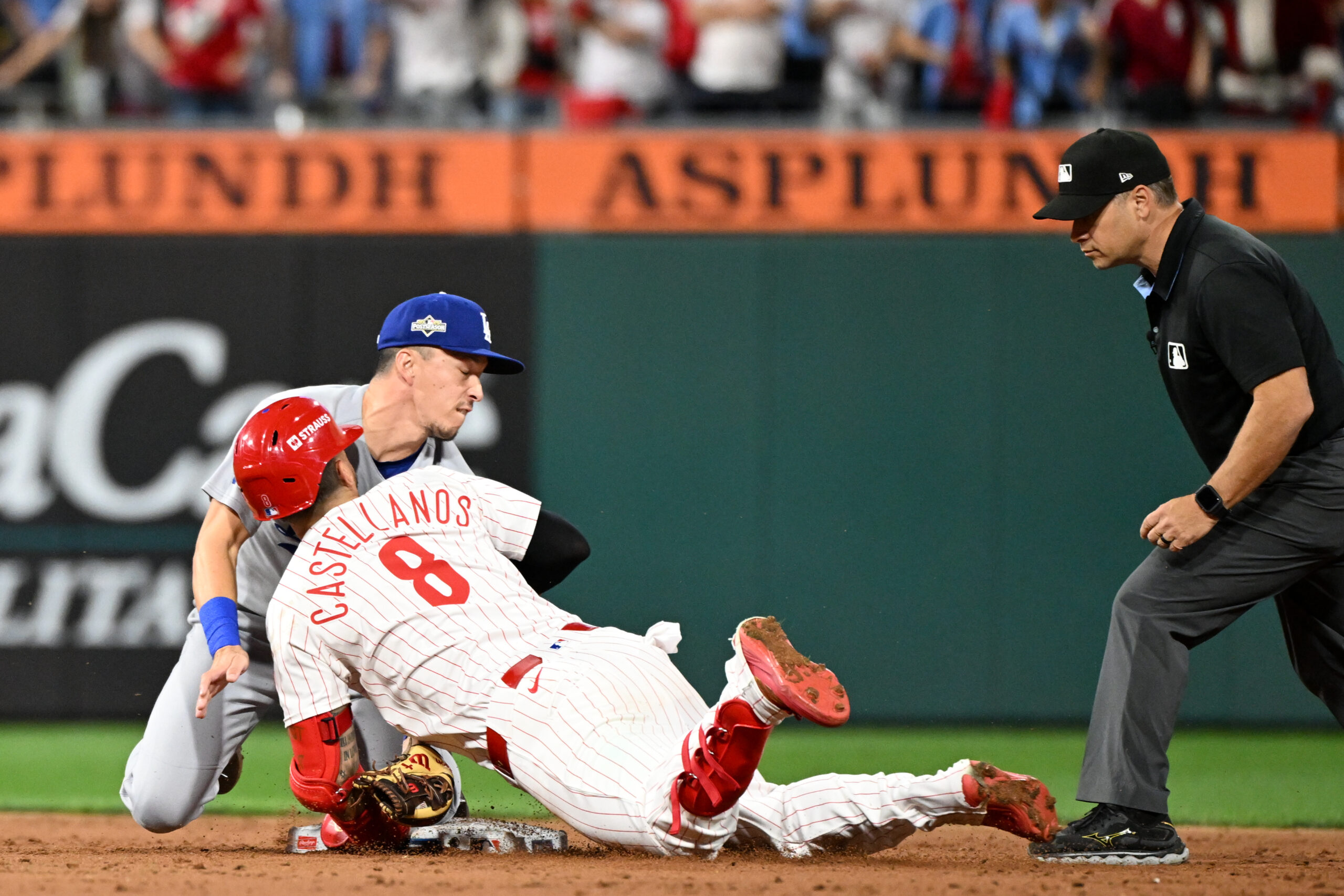 Oct 6, 2025; Philadelphia, Pennsylvania, USA; Philadelphia Phillies right fielder Nick Castellanos (8) slides into second base safely against Los Angeles Dodgers second baseman Tommy Edman (25) in the ninth inning during game two of the NLDS round for the 2025 MLB playoffs at Citizens Bank Park. Mandatory Credit: Eric Hartline-Imagn Images