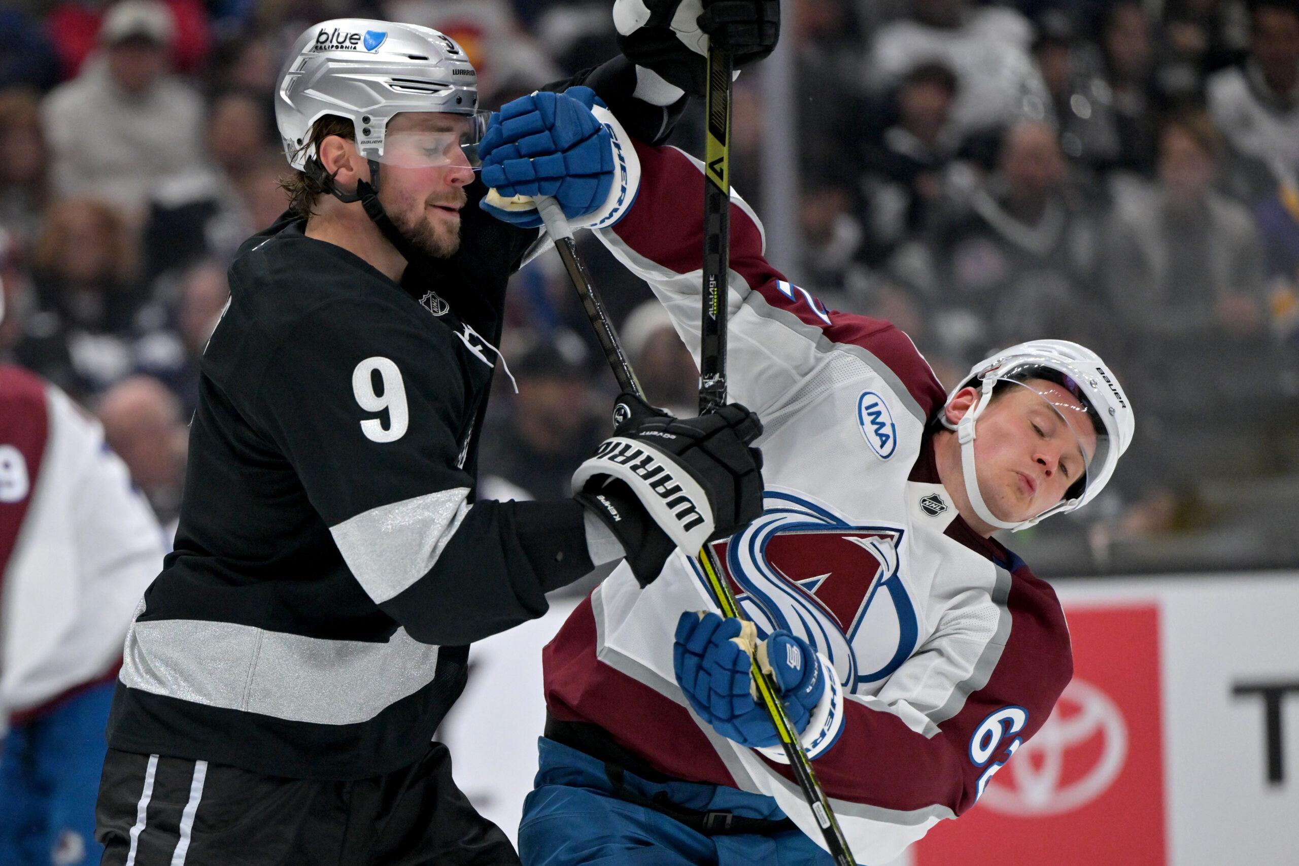 Oct 7, 2025; Los Angeles, California, USA;  Los Angeles Kings right wing Adrian Kempe (9) and Colorado Avalanche left wing Artturi Lehkonen (62) battle for position on the ice during the third period at Crypto.com Arena. Mandatory Credit: Jayne Kamin-Oncea-Imagn Images