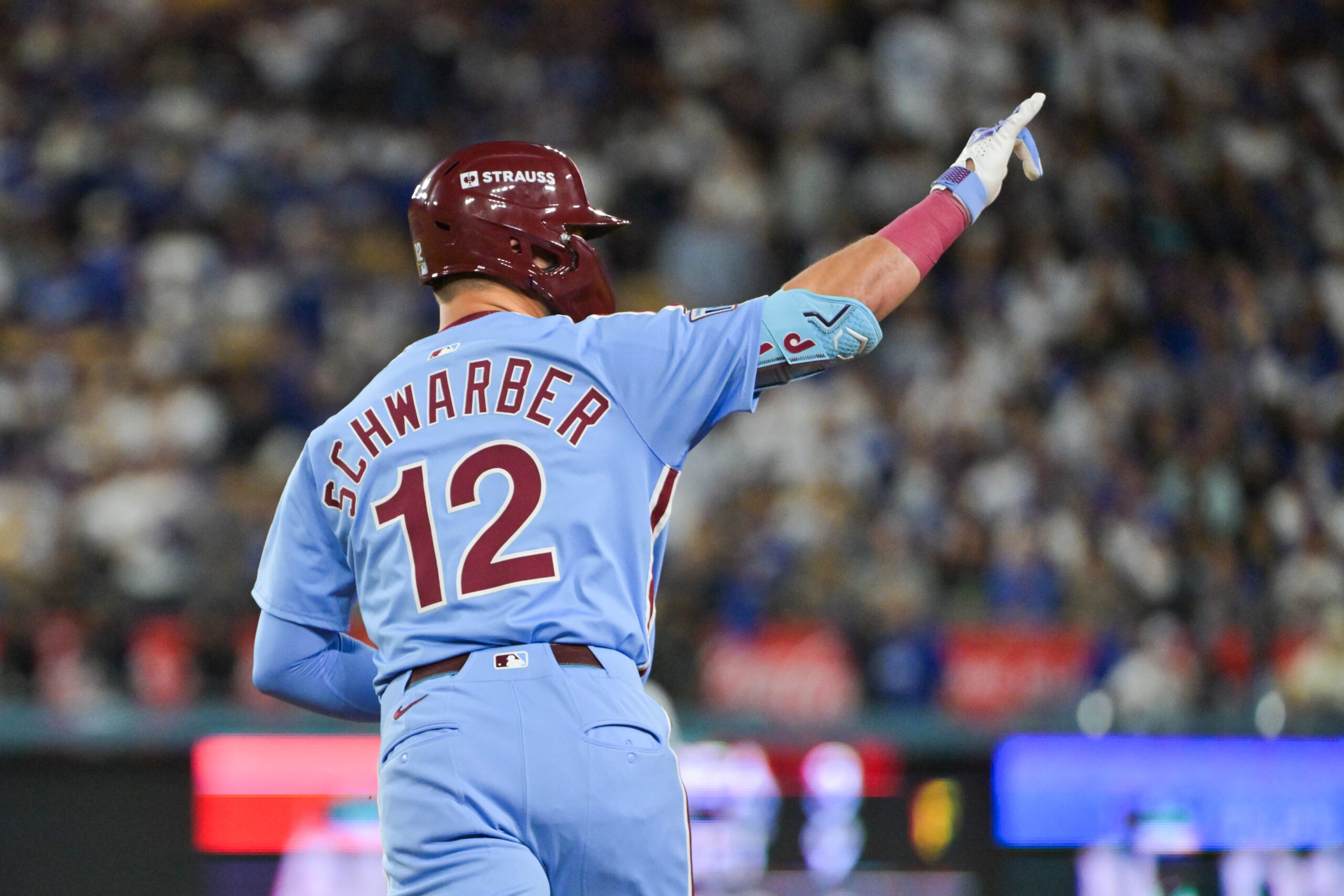 Oct 8, 2025; Los Angeles, California, USA; Philadelphia Phillies designated hitter Kyle Schwarber (12) celebrates after hitting a solo home run during the fourth inning against the Los Angeles Dodgers during game three of the NLDS round for the 2025 MLB playoffs at Dodger Stadium. Mandatory Credit: Jayne Kamin-Oncea-Imagn Images