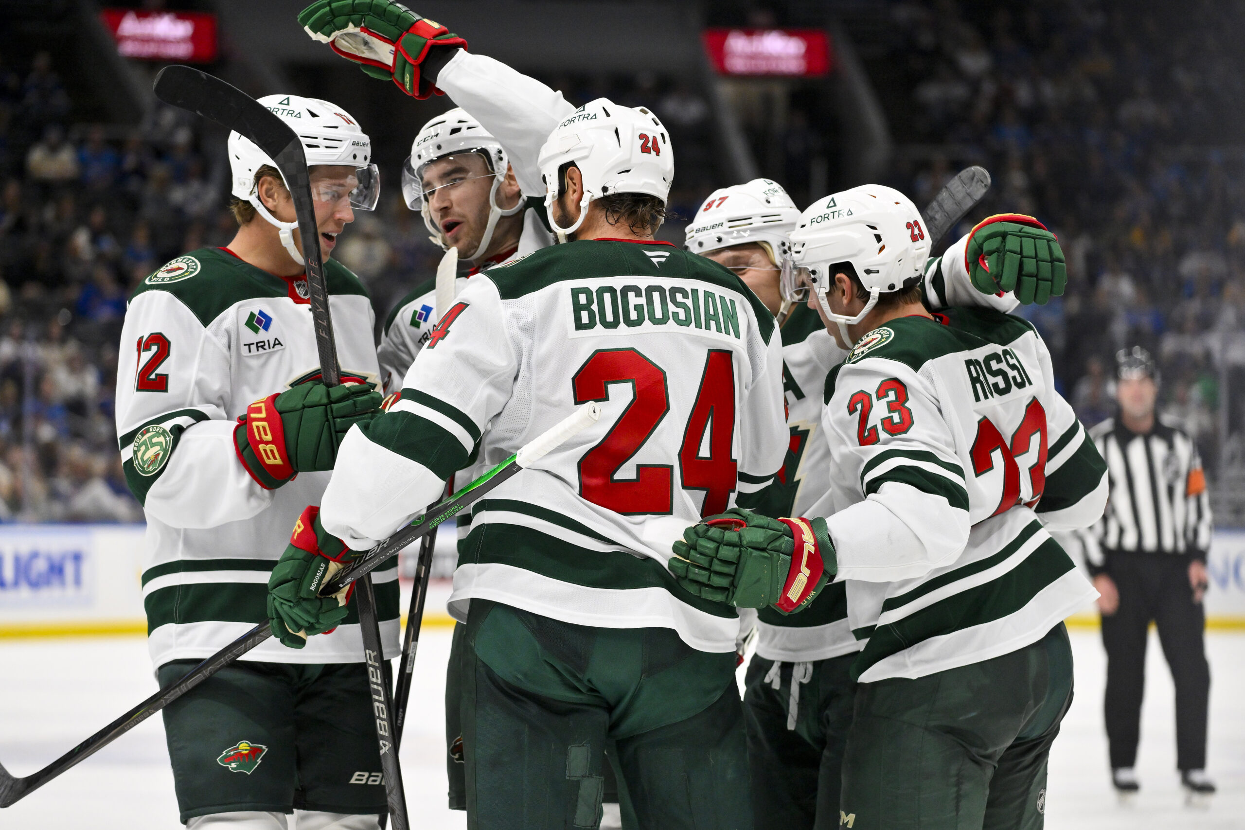 Oct 9, 2025; St. Louis, Missouri, USA; Minnesota Wild center Marco Rossi (23) is congratulated by teammates after scoring against the St. Louis Blues during the third period at Enterprise Center. Mandatory Credit: Jeff Curry-Imagn Images