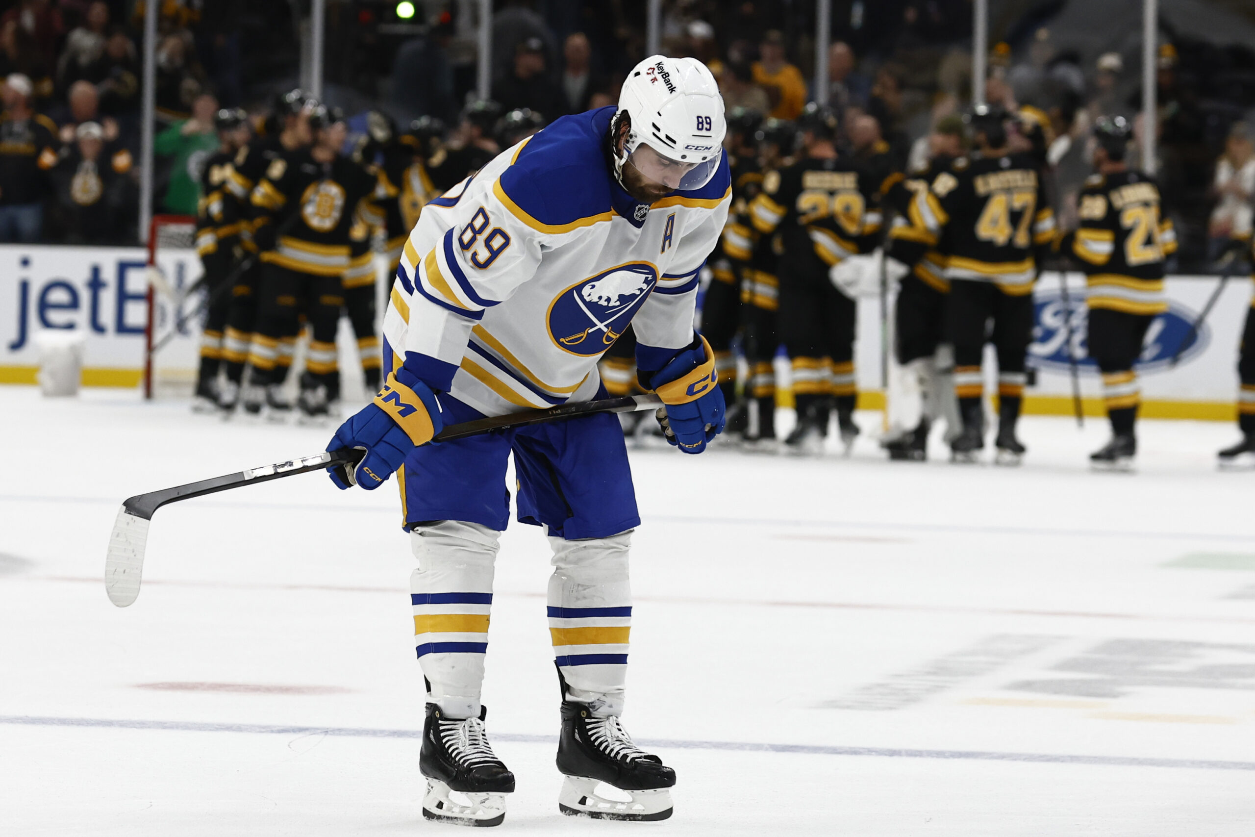 Oct 11, 2025; Boston, Massachusetts, USA; Buffalo Sabres right wing Alex Tuch (89) hangs his head as the Boston Bruins congratulate each other after Boston’s 3-1 win at TD Garden. Mandatory Credit: Winslow Townson-Imagn Images