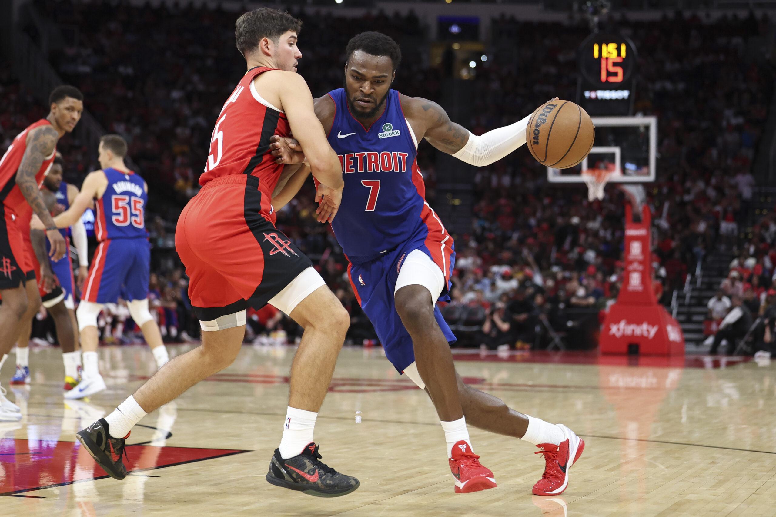 Oct 24, 2025; Houston, Texas, USA; Detroit Pistons forward Paul Reed (7) drives with the ball as Houston Rockets guard Reed Sheppard (15) defends during the fourth quarter at Toyota Center. Mandatory Credit: Troy Taormina-Imagn Images