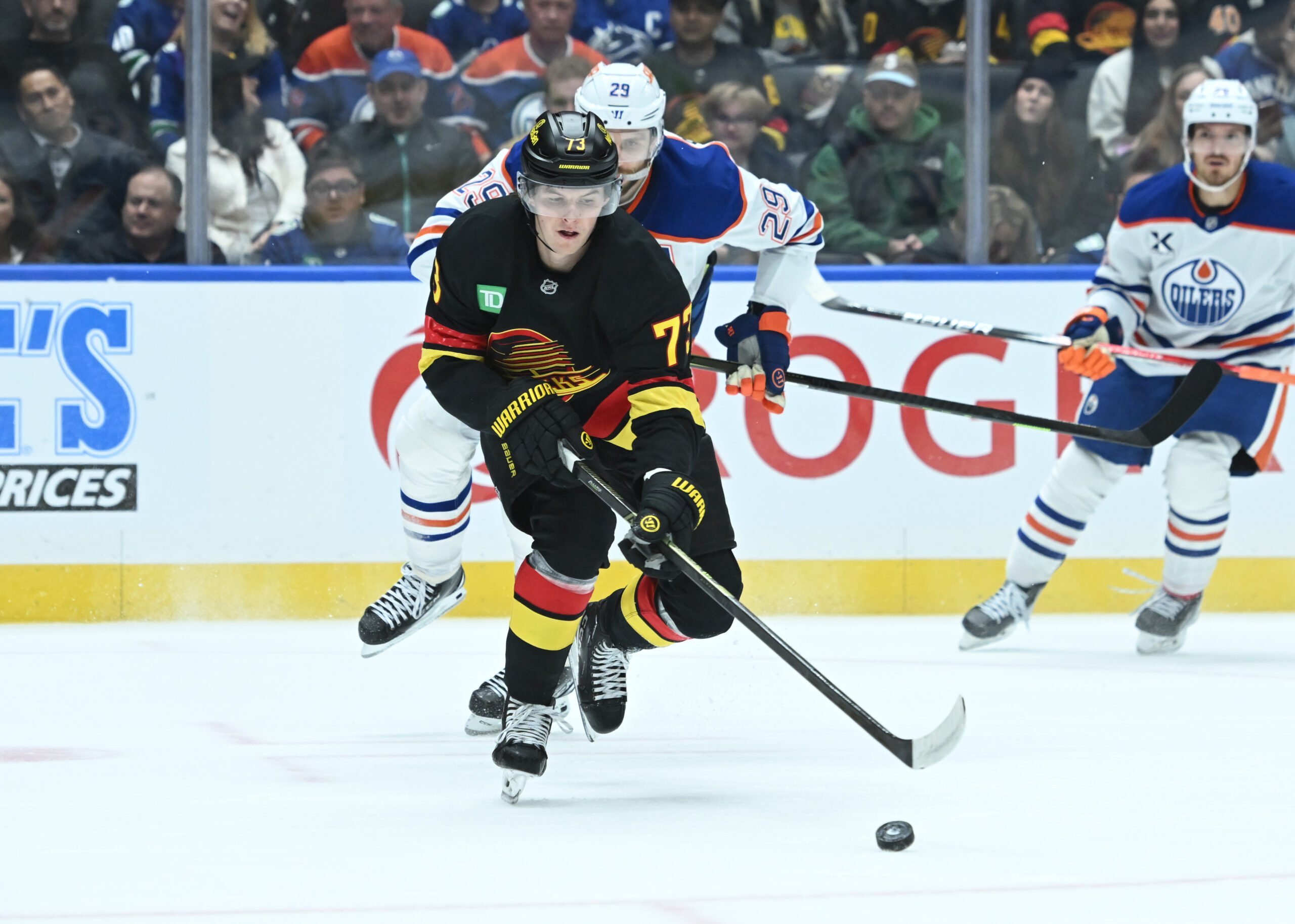 Oct 26, 2025; Vancouver, British Columbia, CAN;Vancouver Canucks left wing  Lucas Reichel (73) skates with the puck against Edmonton Oilers during the second period at Rogers Arena. Mandatory Credit: Simon Fearn-Imagn Images
