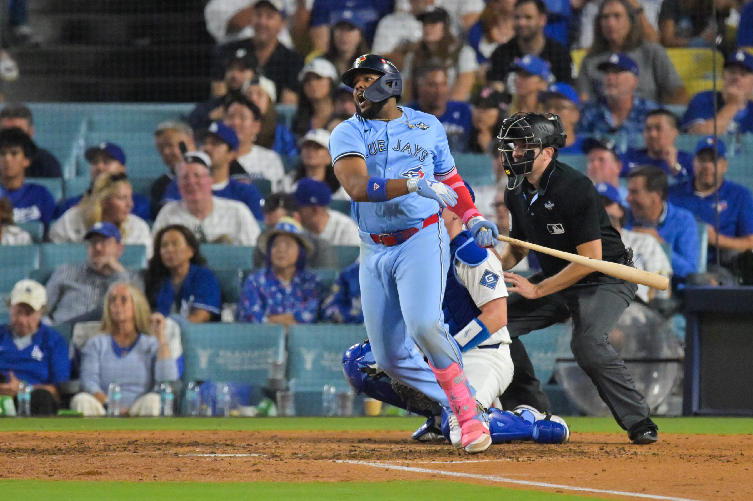 Oct 28, 2025; Los Angeles, California, USA; Toronto Blue Jays first baseman Vladimir Guerrero Jr. (27) hits a single during the ninth inning against the Los Angeles Dodgers during game four of the 2025 MLB World Series at Dodger Stadium. Mandatory Credit: Jayne Kamin-Oncea-Imagn Images