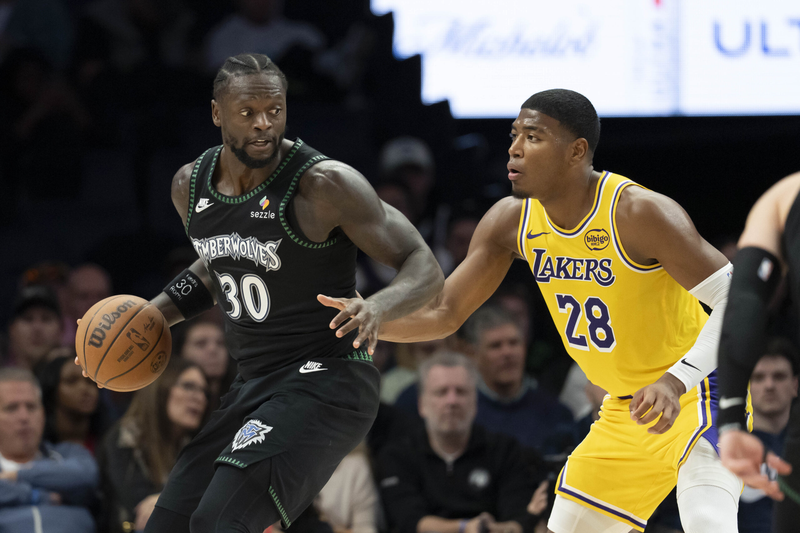 Oct 29, 2025; Minneapolis, Minnesota, USA; Minnesota Timberwolves forward Julius Randle (30) dribbles as Los Angeles Lakers forward Rui Hachimura (28) plays defense in the second half at Target Center. Mandatory Credit: Jesse Johnson-Imagn Images