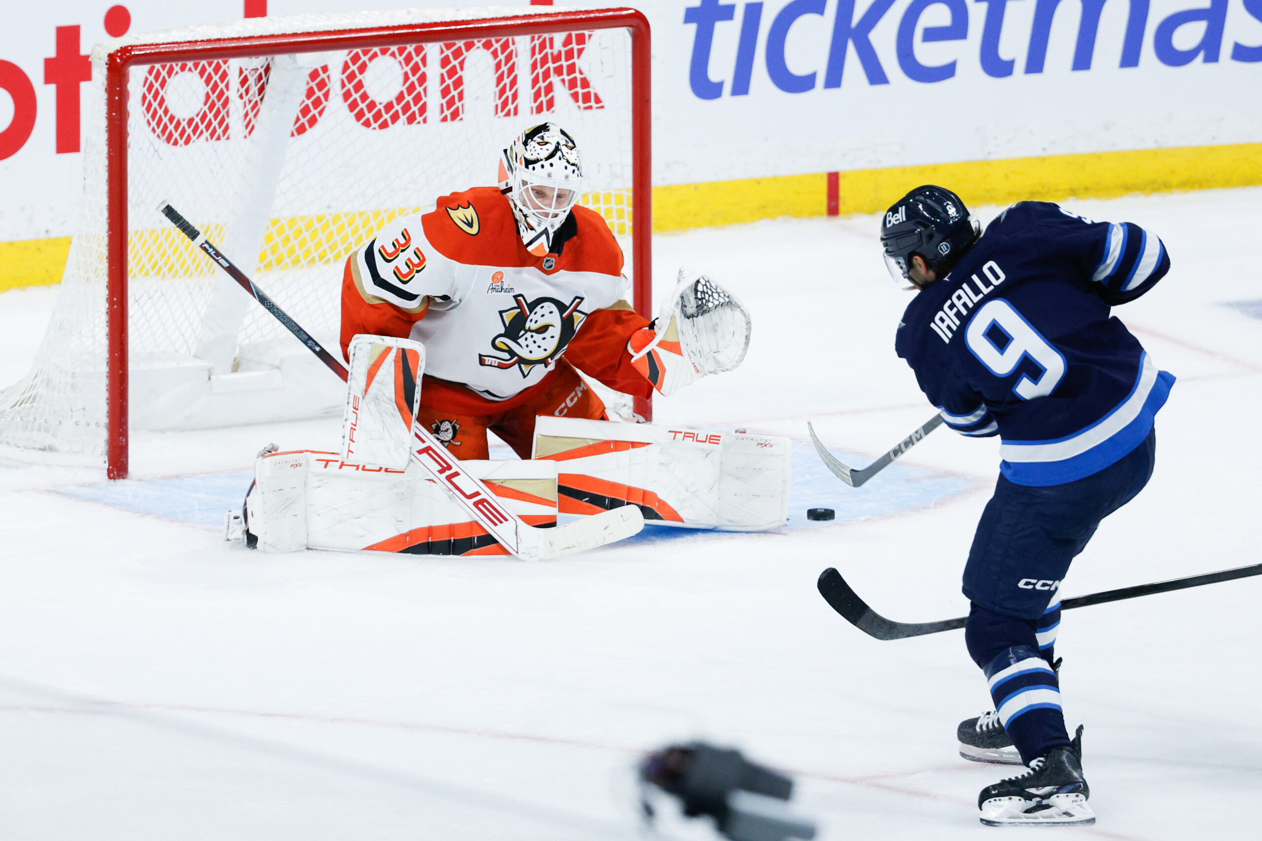 Apr 16, 2025; Winnipeg, Manitoba, CAN;  Winnipeg Jets forward Alex Iafallo (9) takes a shot on Anaheim Ducks goalie Ville Husso (33) during the third period at Canada Life Centre. Mandatory Credit: Terrence Lee-Imagn Images