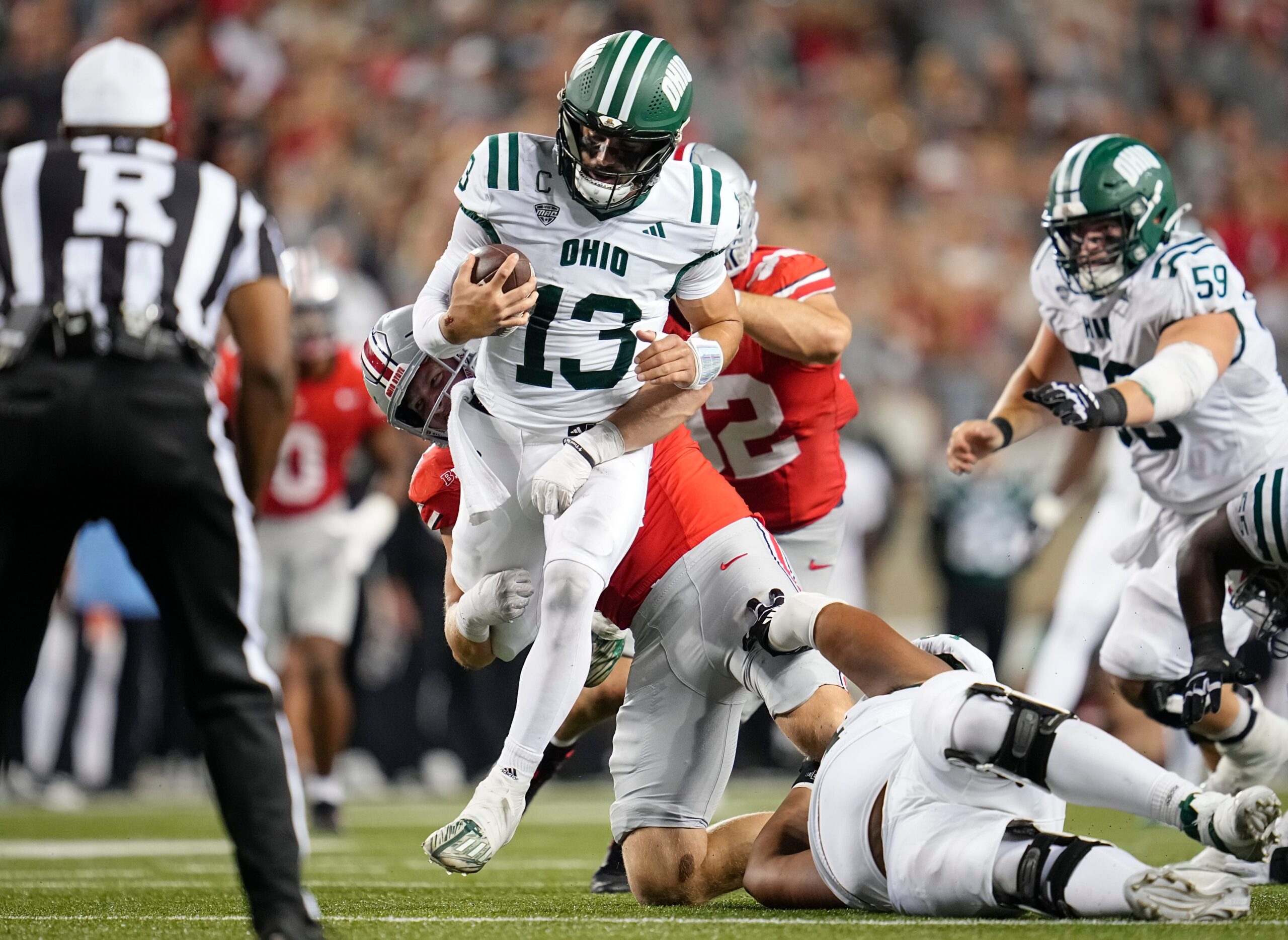Ohio State Buckeyes defensive lineman Beau Atkinson (14) sacks Ohio Bobcats quarterback Parker Navarro (13) during the second half of the NCAA football game at Ohio Stadium on Sept. 13, 2025. Ohio State won 37-9.