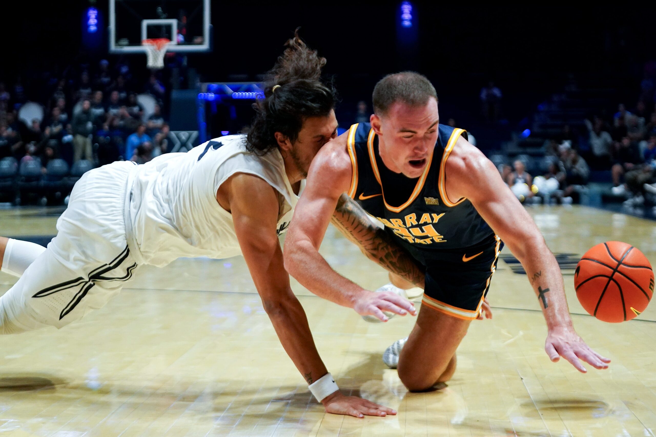 Xavier Musketeers forward Tre Carroll (12) and Murray State Racers guard Brayden Shorter (34) collide in the second half of a NCAA men’s basketball game between the Xavier Musketeers and Murray State Racers, Saturday, Oct. 18, 2025, at Cintas Center in Cincinnati. Racers won 75-70.