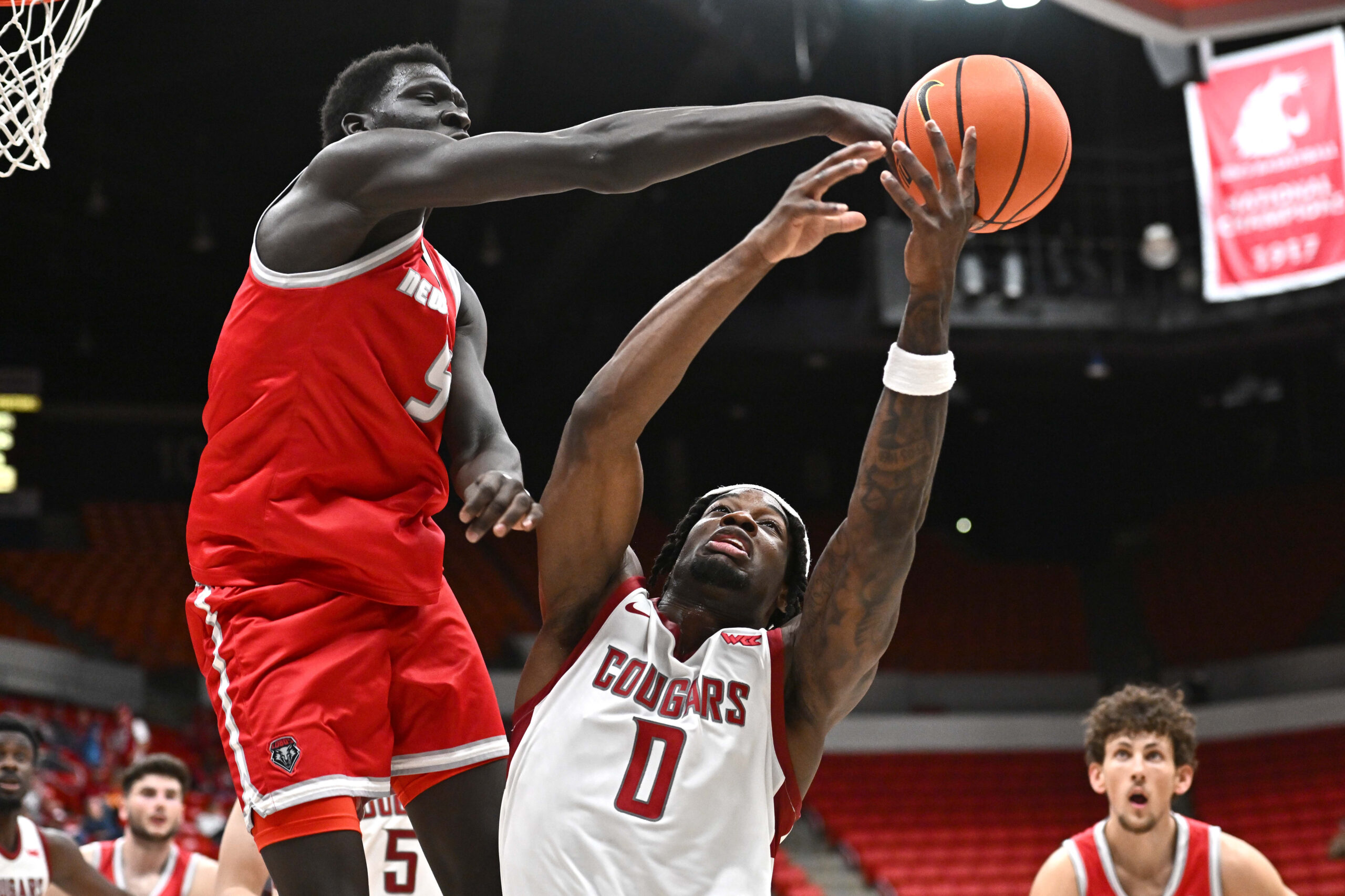 Oct 25, 2025; Pullman, WA, USA; New Mexico Lobos forward Antonio Chol (5) fights for the rebound against Washington State Cougars forward Emmanuel Ugbo (0) in the second half at Friel Court at Beasley Coliseum. Mandatory Credit: James Snook-Imagn Images