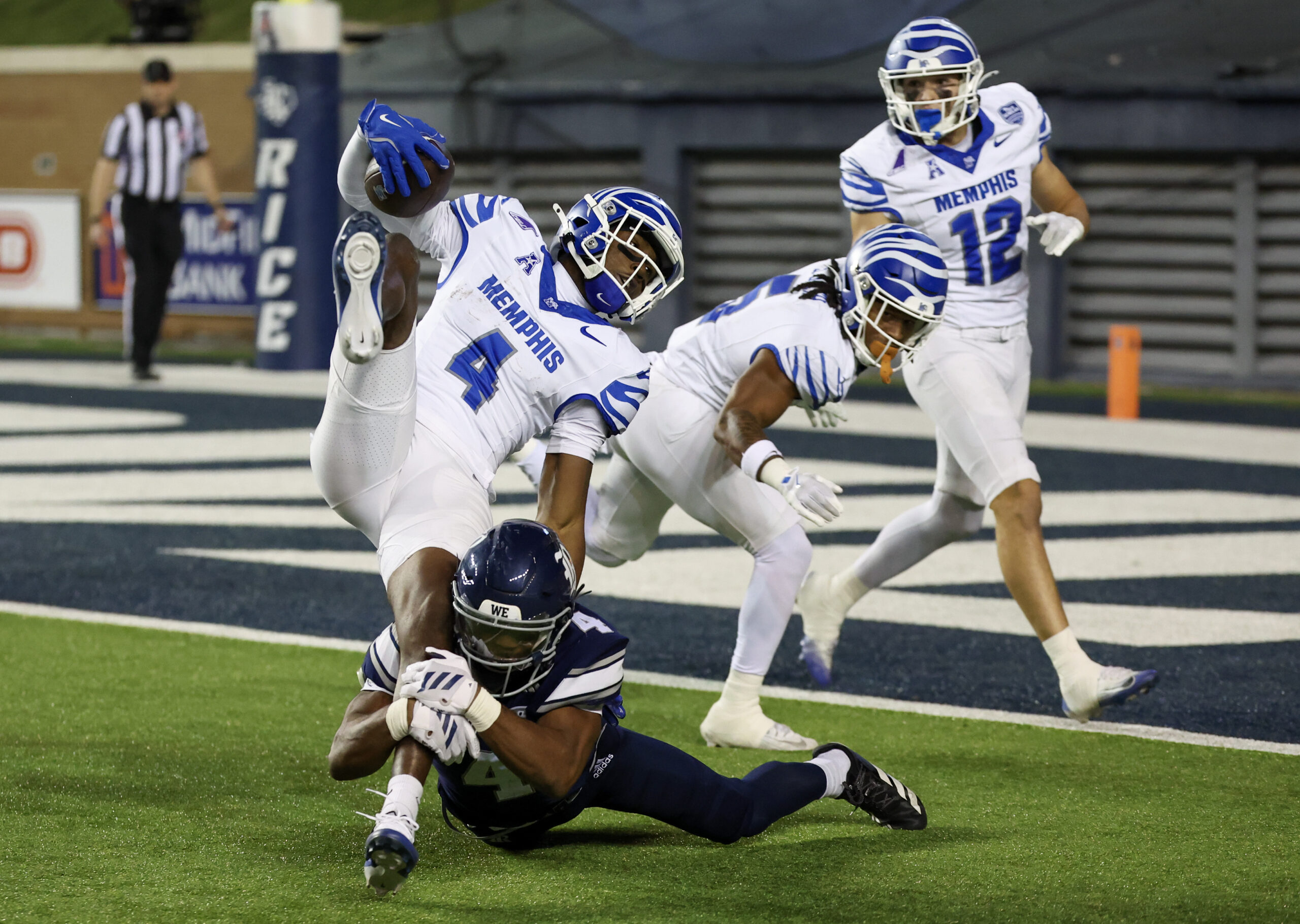 Oct 31, 2025; Houston, Texas, USA; Memphis Tigers wide receiver Cortez Braham Jr. (4) is tackled by Rice Owls safety Marcus Williams (4) in the second half at Rice Stadium. Mandatory Credit: Thomas Shea-Imagn Images