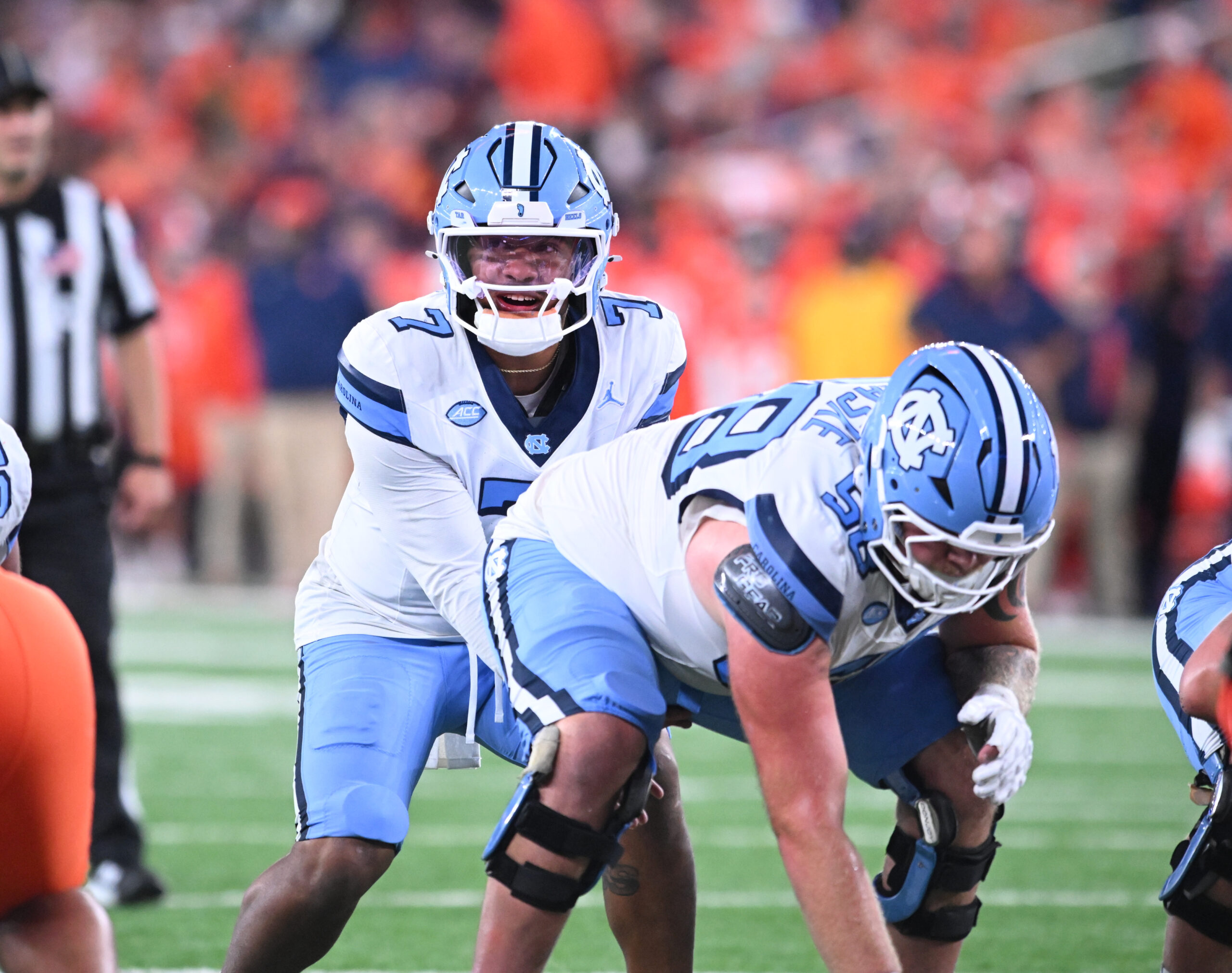 Oct 31, 2025; Syracuse, New York, USA; North Carolina Tar Heels quarterback Gio Lopez (7) with center Austin Blaske (58) at the line of scrimmage in the third quarter against the Syracuse Orange at the JMA Wireless Dome. Mandatory Credit: Mark Konezny-Imagn Images