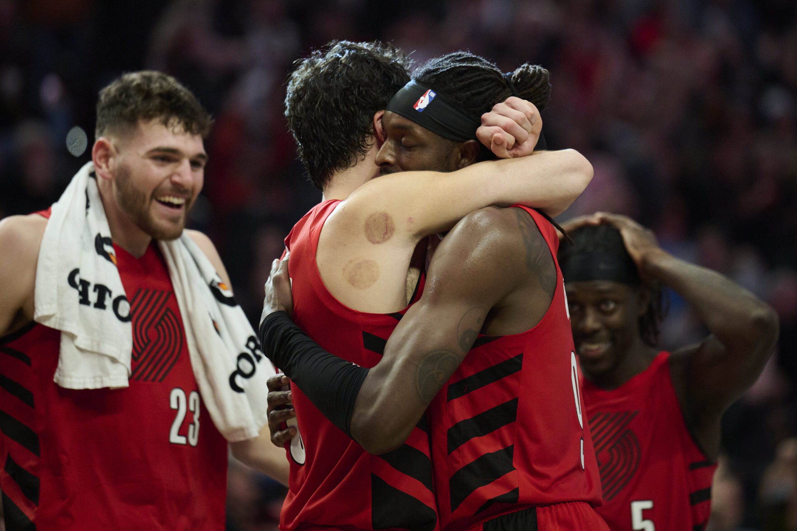 Oct 31, 2025; Portland, Oregon, USA; Portland Trail Blazers forward Jerami Grant (9), right, celebrates with forward Deni Avdija (8) after a game against the Denver Nuggets at Moda Center. Grant scored the game winning free throws. Mandatory Credit: Troy Wayrynen-Imagn Images