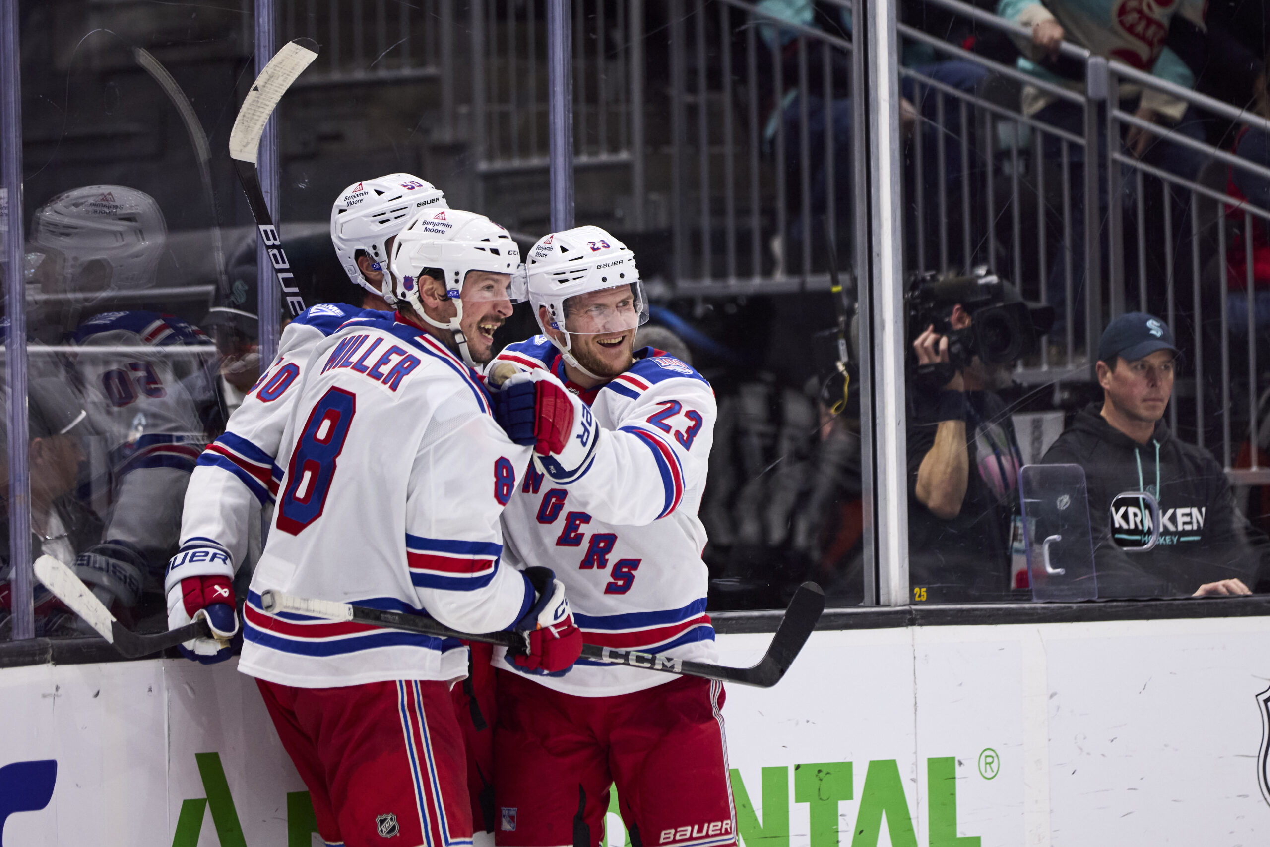Nov 1, 2025; Seattle, Washington, USA; New York Rangers left wing Will Cuylle (50), New York Rangers defenseman Adam Fox (23), and New York Rangers center J.T. Miller (8) celebrate an overtime win against the Seattle Kraken at Climate Pledge Arena. Mandatory Credit: Blake Dahlin-Imagn Images