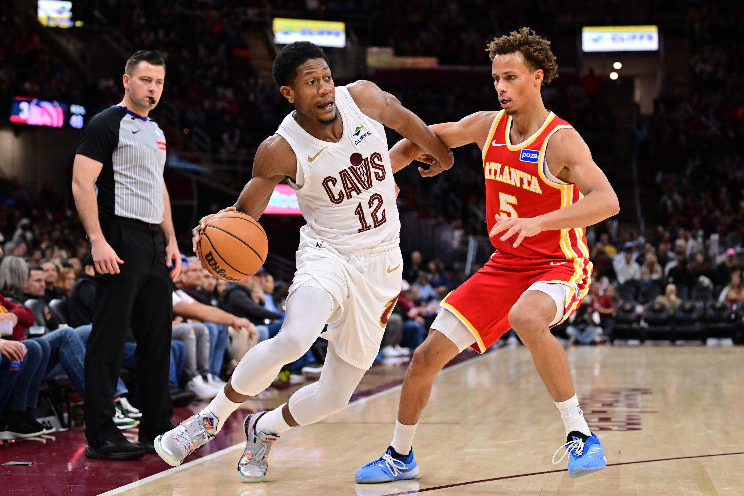 Nov 2, 2025; Cleveland, Ohio, USA; Cleveland Cavaliers forward De'Andre Hunter (12) drives to the basket against Atlanta Hawks guard Dyson Daniels (5) during the second half at Rocket Arena. Mandatory Credit: Ken Blaze-Imagn Images