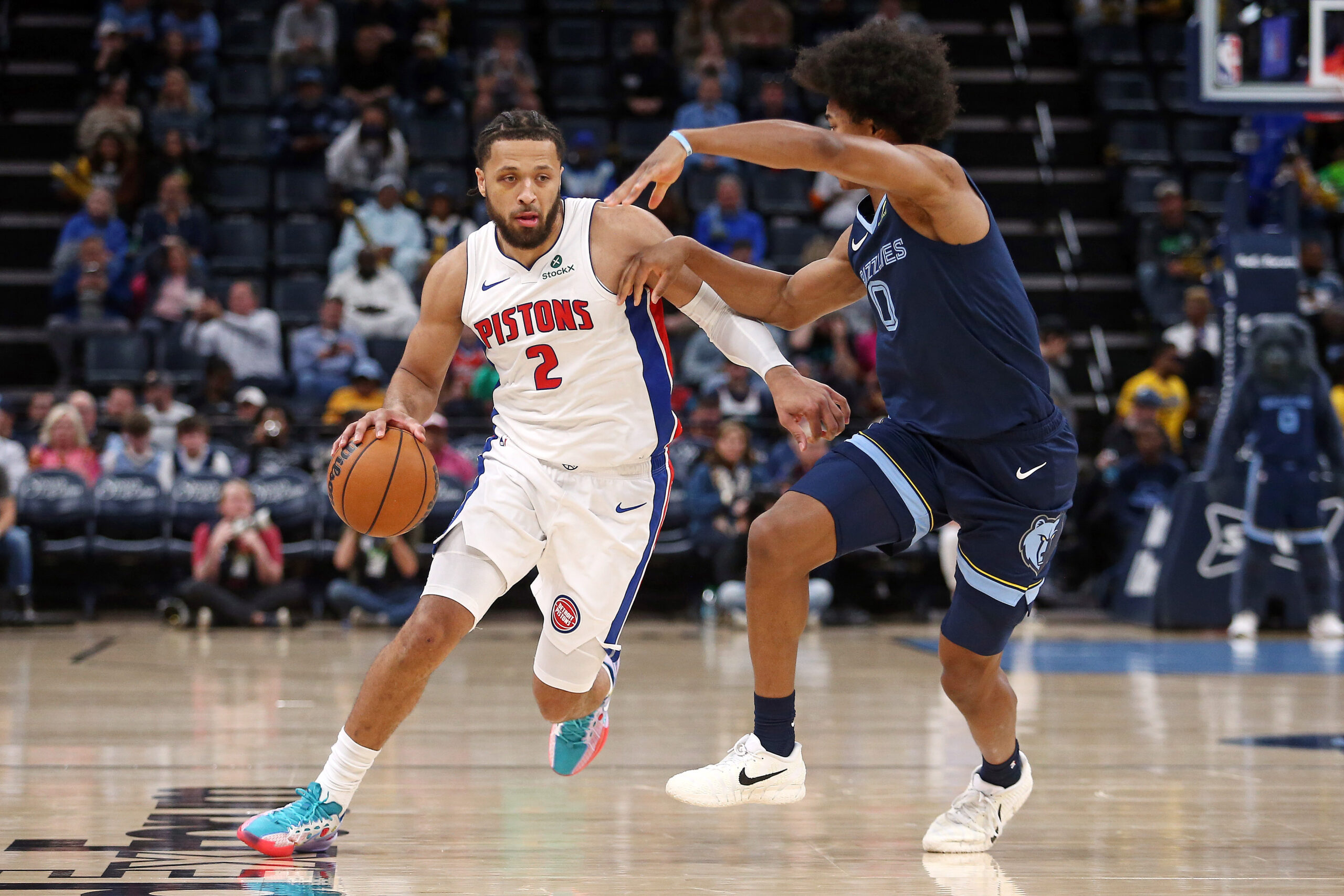 Nov 3, 2025; Memphis, Tennessee, USA; Detroit Pistons guard Cade Cunningham (2) dribbles as Memphis Grizzlies forward Jaylen Wells (0) during the first quarter at FedExForum. Mandatory Credit: Petre Thomas-Imagn Images