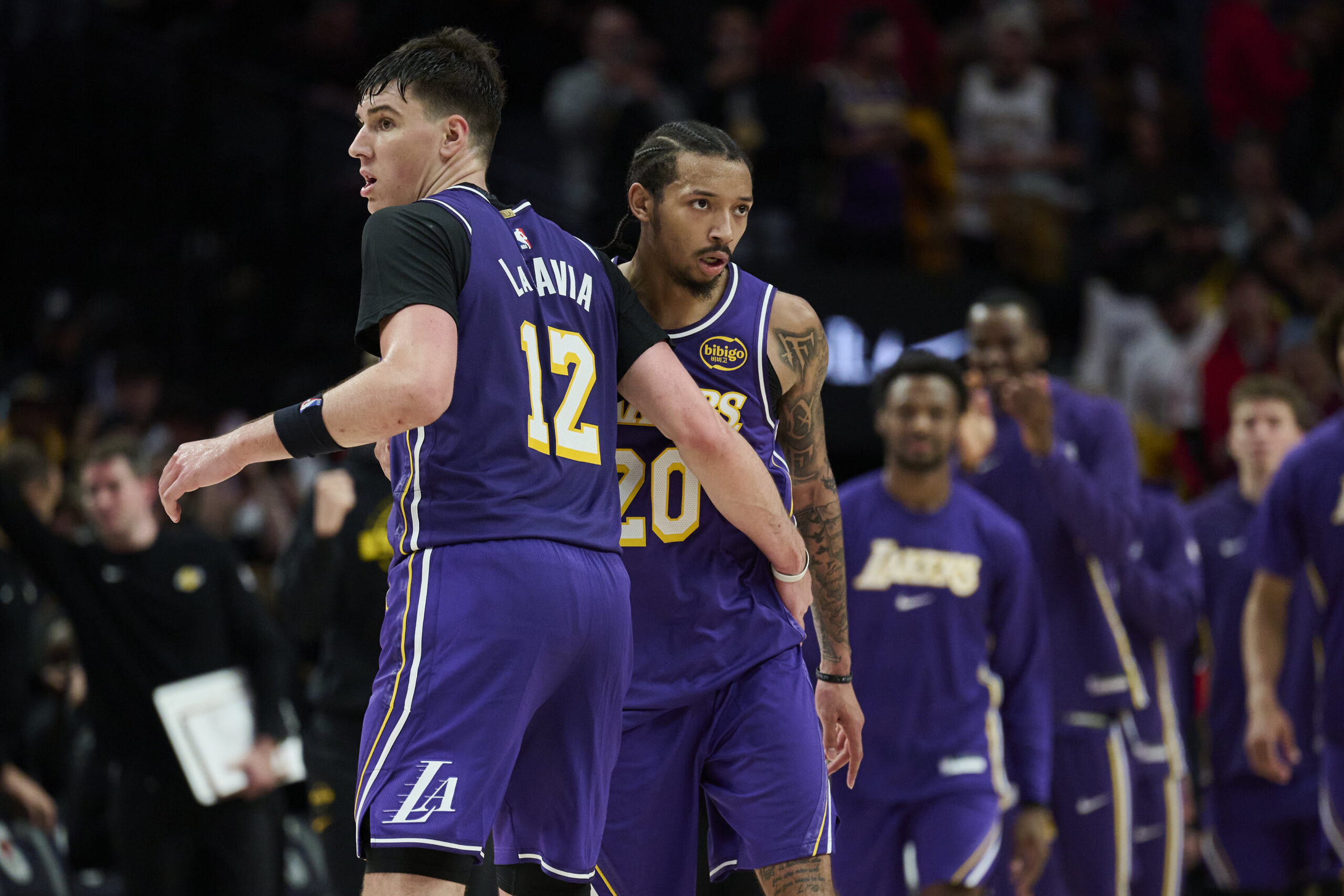 Nov 3, 2025; Portland, Oregon, USA; Los Angeles Lakers guard Nick Smith Jr. (20) celebrates with teammate forward Jake LaRavia (12) after a game against the Portland Trail Blazers at Moda Center. Mandatory Credit: Troy Wayrynen-Imagn Images