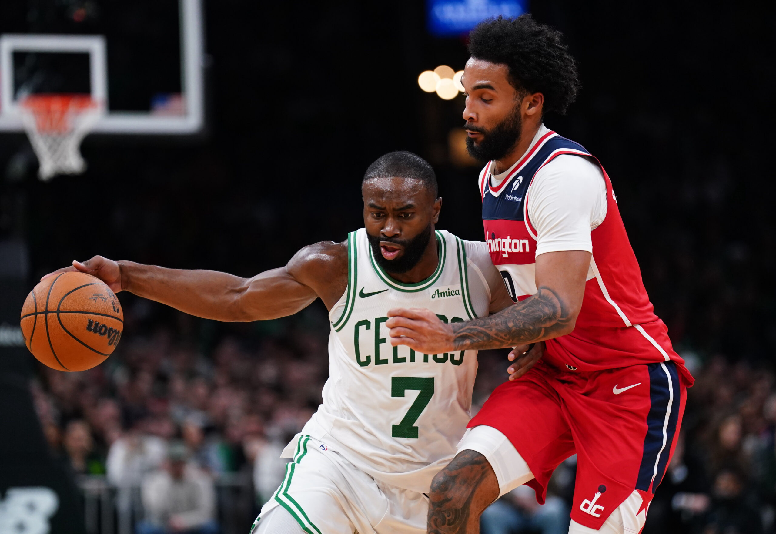 Nov 5, 2025; Boston, Massachusetts, USA; Boston Celtics guard/forward Jaylen Brown (7) drives the ball against Washington Wizards guard/forward Justin Champagnie (9)  in the second half at TD Garden. Mandatory Credit: David Butler II-Imagn Images