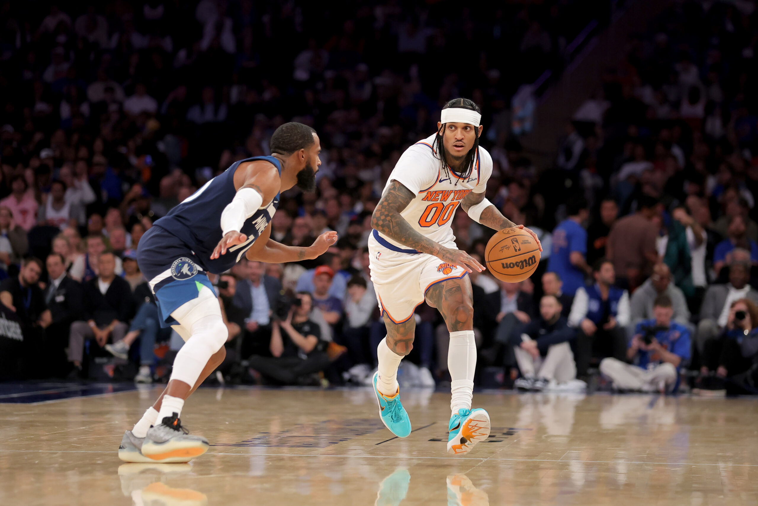 Nov 5, 2025; New York, New York, USA; New York Knicks guard Jordan Clarkson (00) brings the ball up court against Minnesota Timberwolves guard Mike Conley (10) during the fourth quarter at Madison Square Garden. Mandatory Credit: Brad Penner-Imagn Images