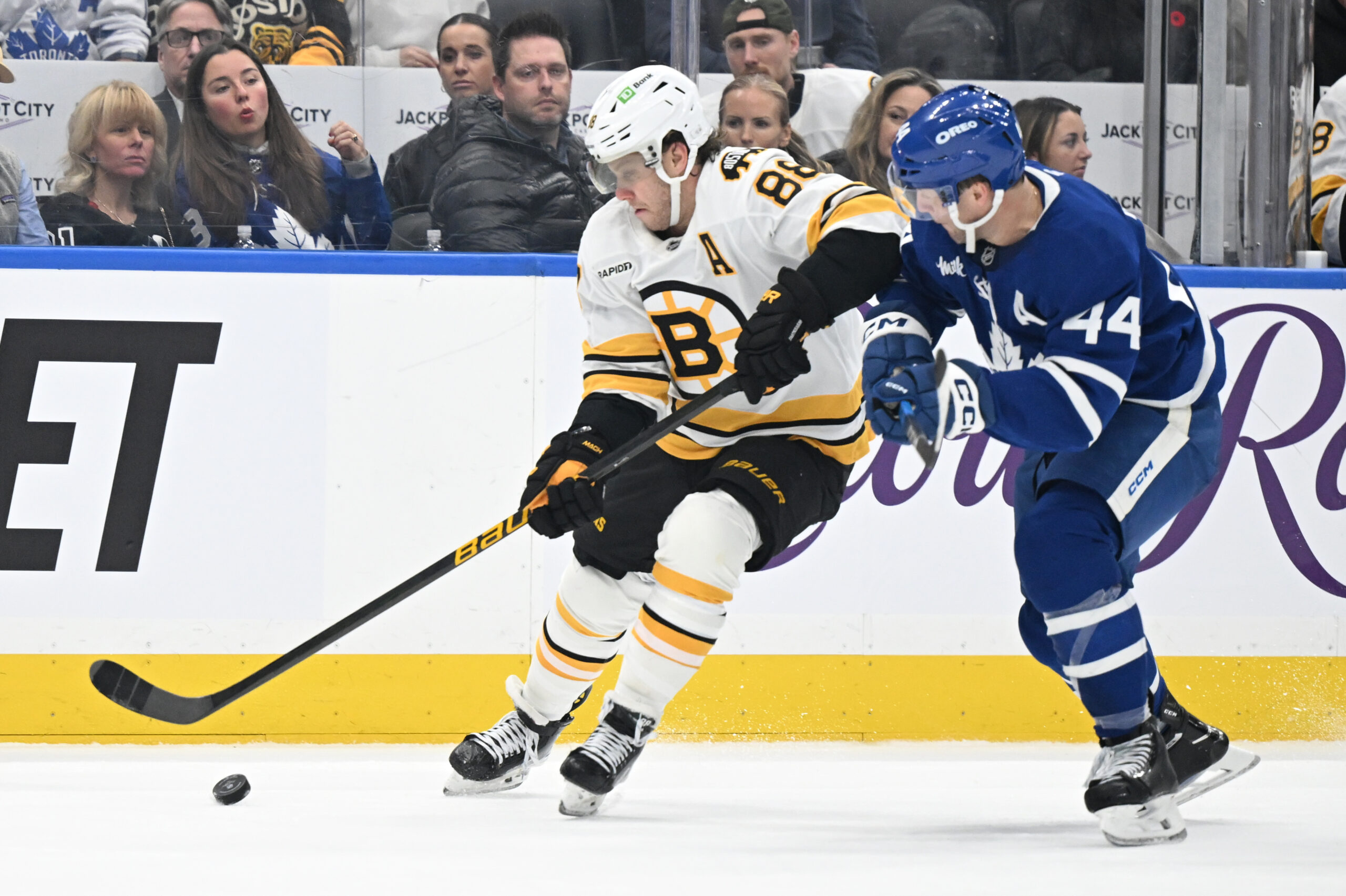 Nov 8, 2025; Toronto, Ontario, CAN;  Boston Bruins forward David Pastrnak (88) moves the puck past Toronto Maple Leafs defenseman Morgan Rielly (44) in the second period at Scotiabank Arena. Mandatory Credit: Dan Hamilton-Imagn Images