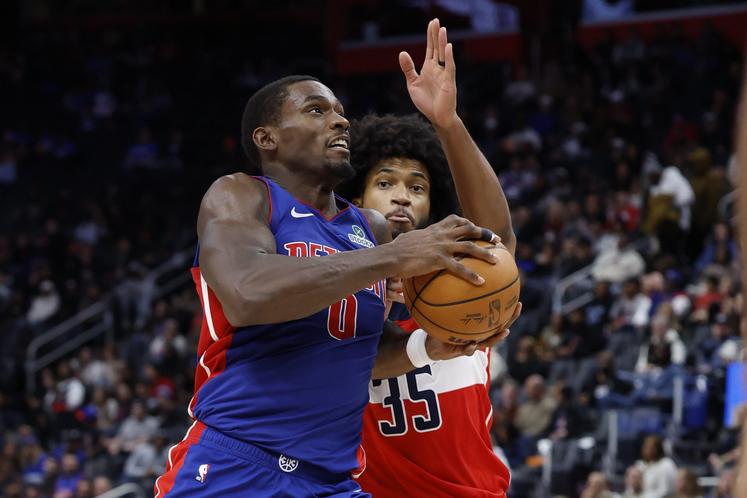Nov 10, 2025; Detroit, Michigan, USA;  Detroit Pistons center Jalen Duren (0) dribbles defended by Washington Wizards forward Marvin Bagley III (35) in the second half at Little Caesars Arena. Mandatory Credit: Rick Osentoski-Imagn Images