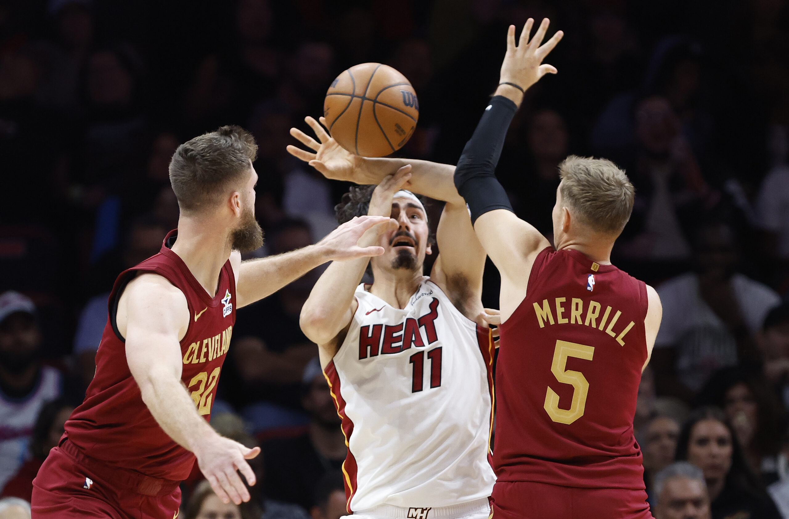 Nov 10, 2025; Miami, Florida, USA;  Cleveland Cavaliers forward Dean Wade (32) and guard Sam Merrill (5) defend Miami Heat forward Jaime Jaquez Jr. (11) during the second half at Kaseya Center. Mandatory Credit: Rhona Wise-Imagn Images